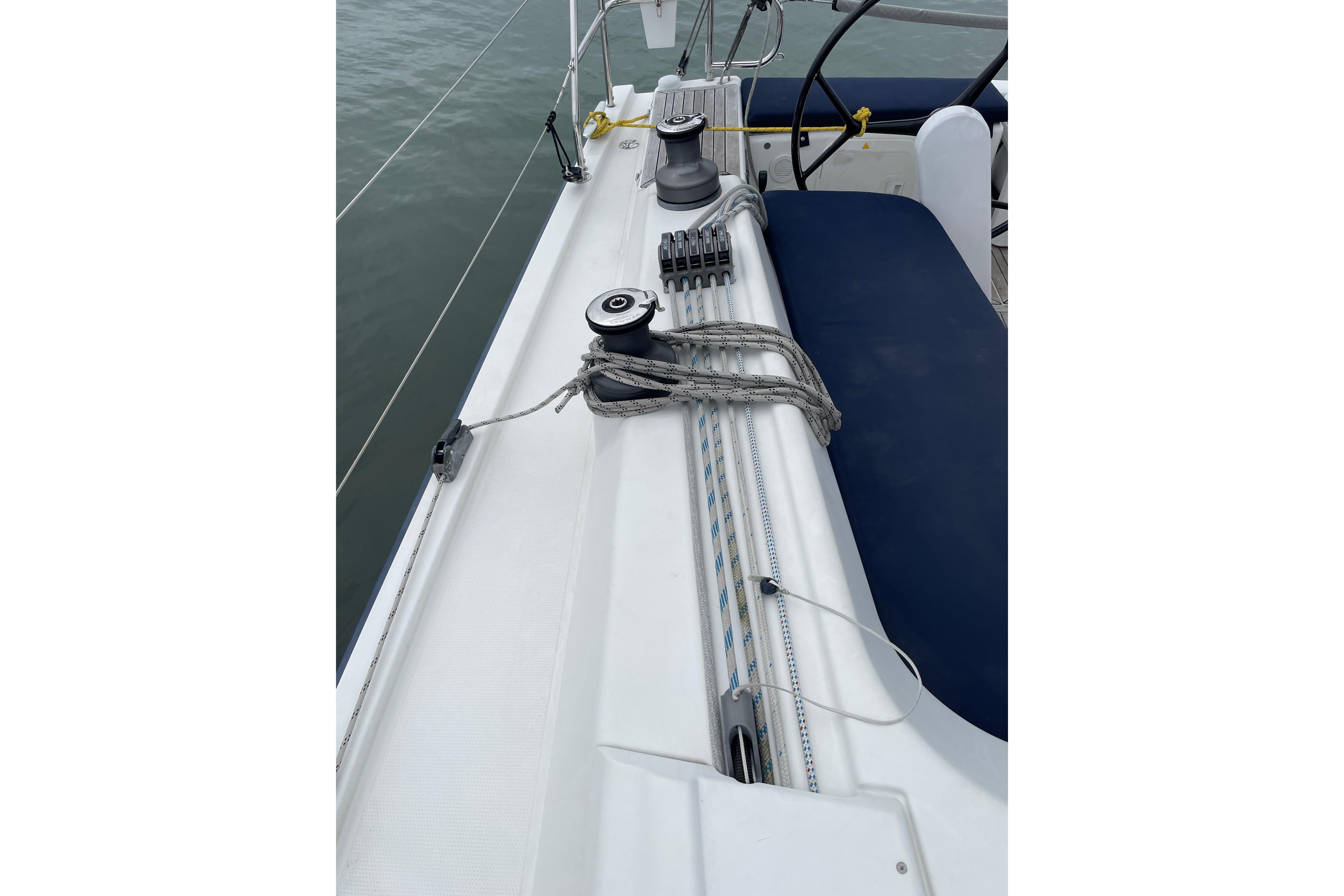Deck of 2014 Hanse 415 sailboat with winches and ropes.