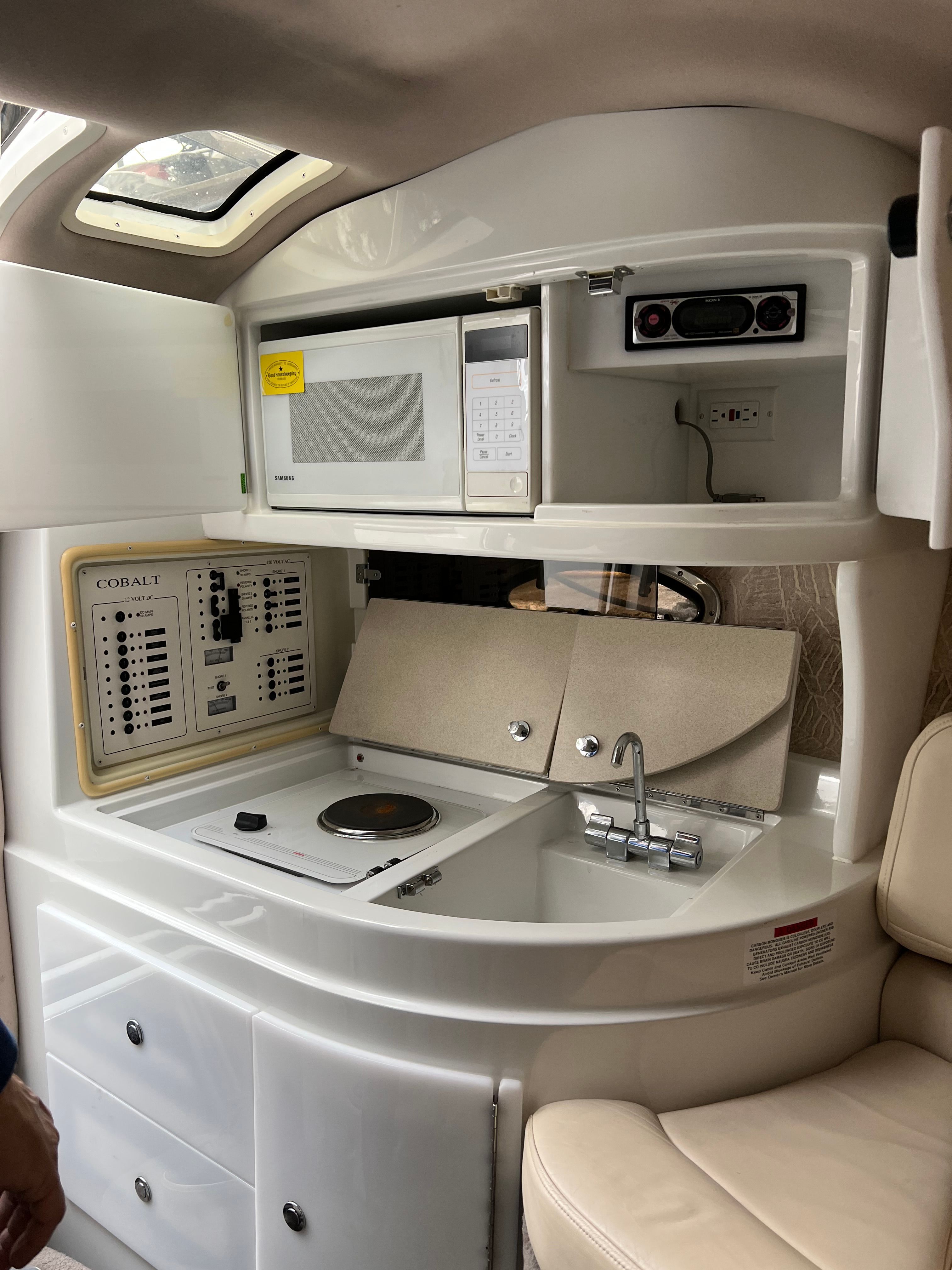 Interior of a 1999 Cobalt 293 yacht with kitchenette and microwave.
