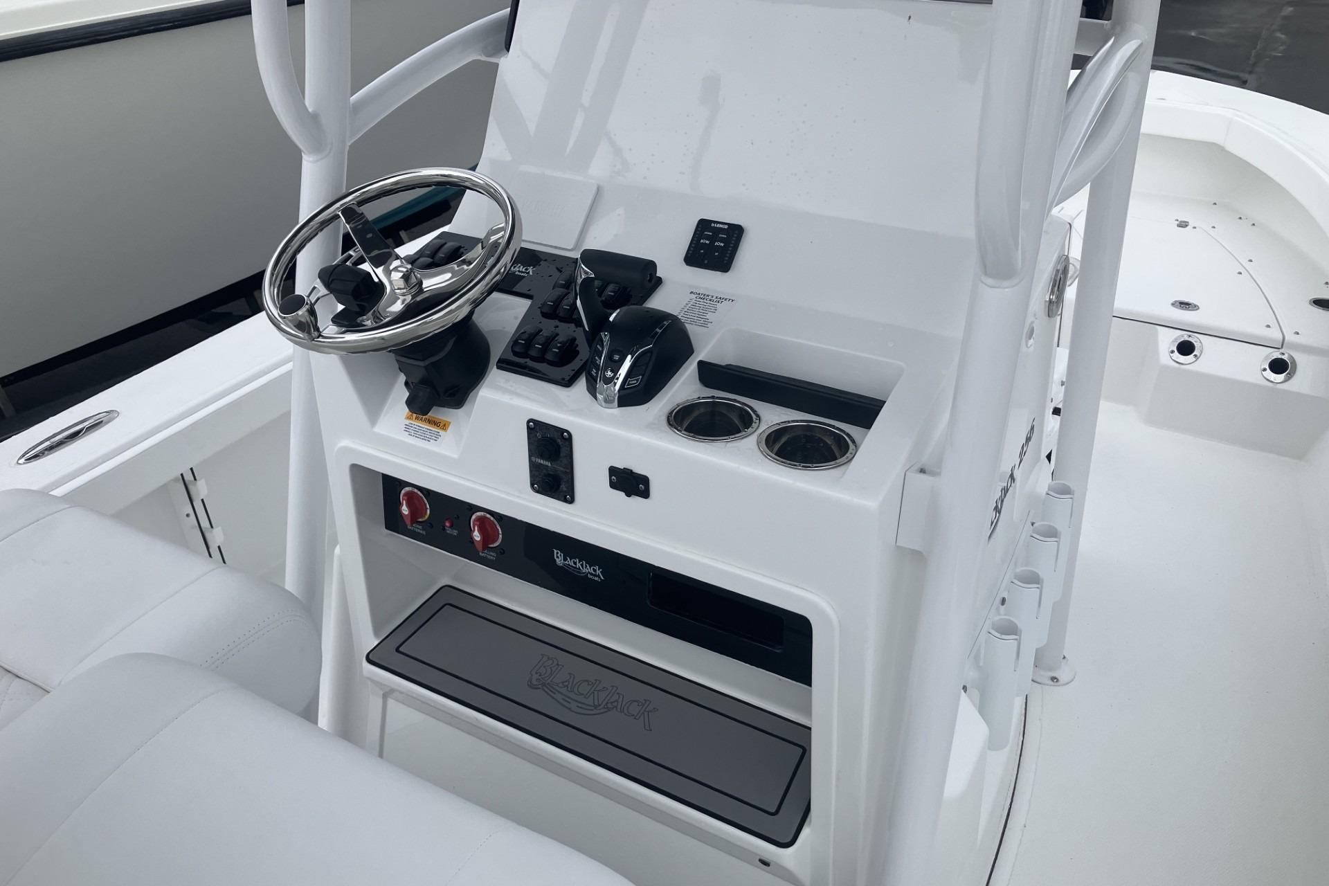 2026 BlackJack 256 Coastal boat console with steering wheel and controls.