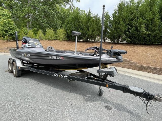 2008 Bee Line Super Vee boat on trailer, parked on a road with trees in background.