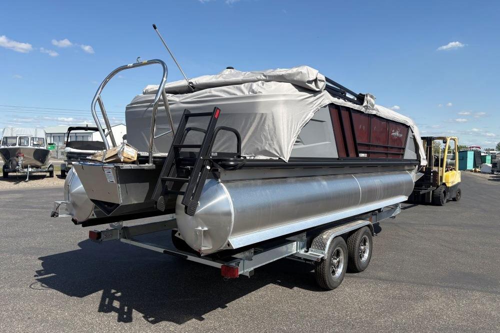2026 SunChaser Lucerne 22 LR DH pontoon boat on trailer, covered and ready for transport.