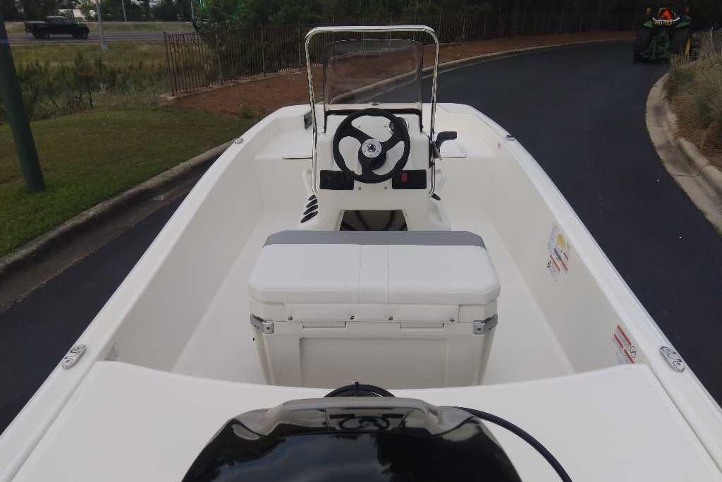 2026 Mako Pro Skiff 15 CC boat interior with steering wheel and seating.