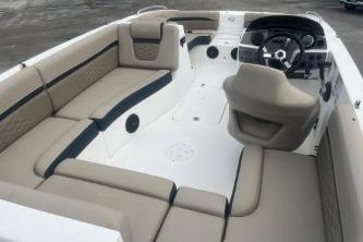 2021 Hurricane SunDeck Sport 192 RL OB boat interior with beige seating and steering console.