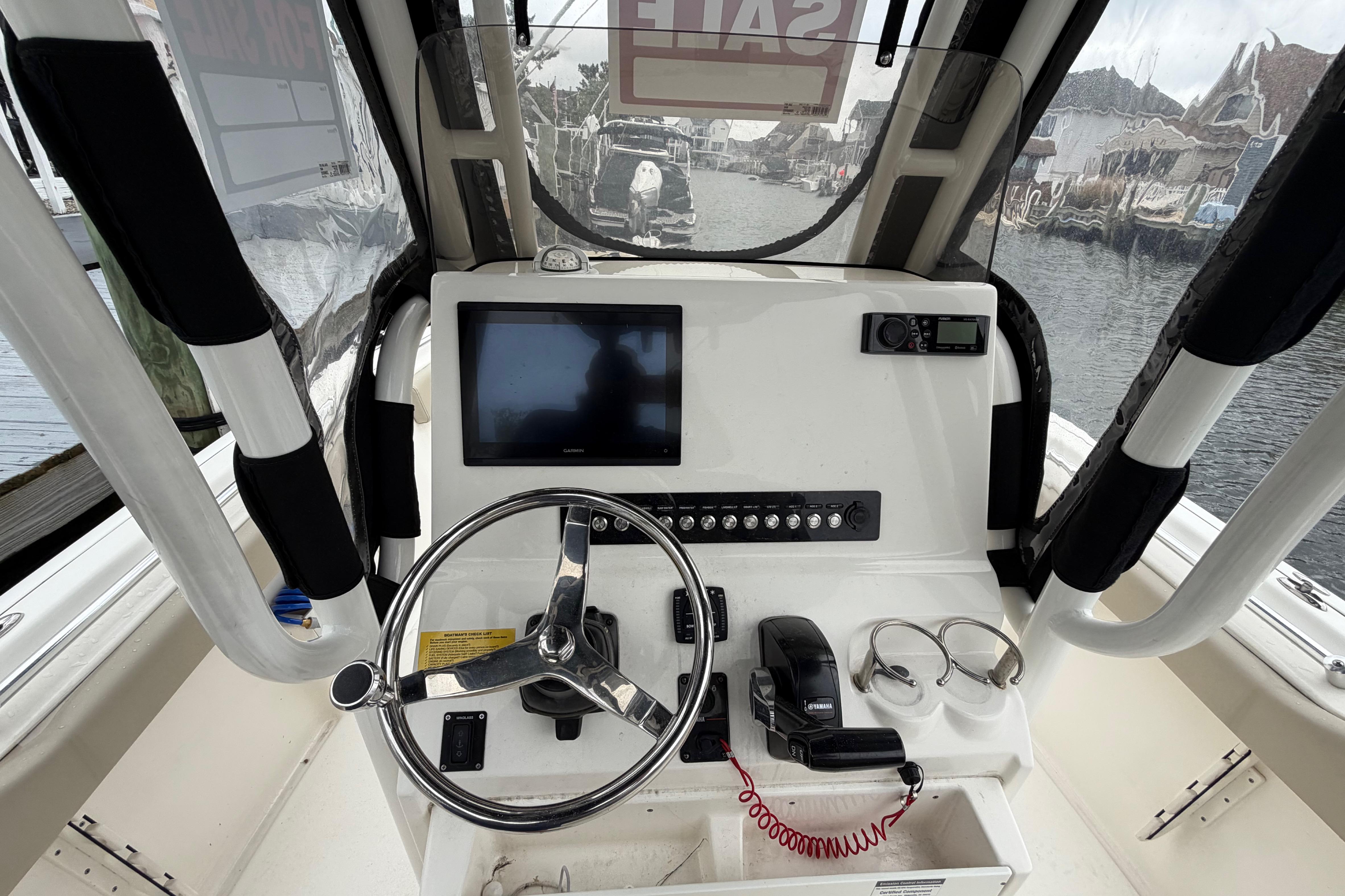 2022 Key West 239 FS boat dashboard with steering wheel and navigation controls.