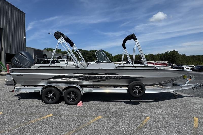 2025 SeaArk Super Lounge Easy boat on trailer, parked outdoors under blue sky.