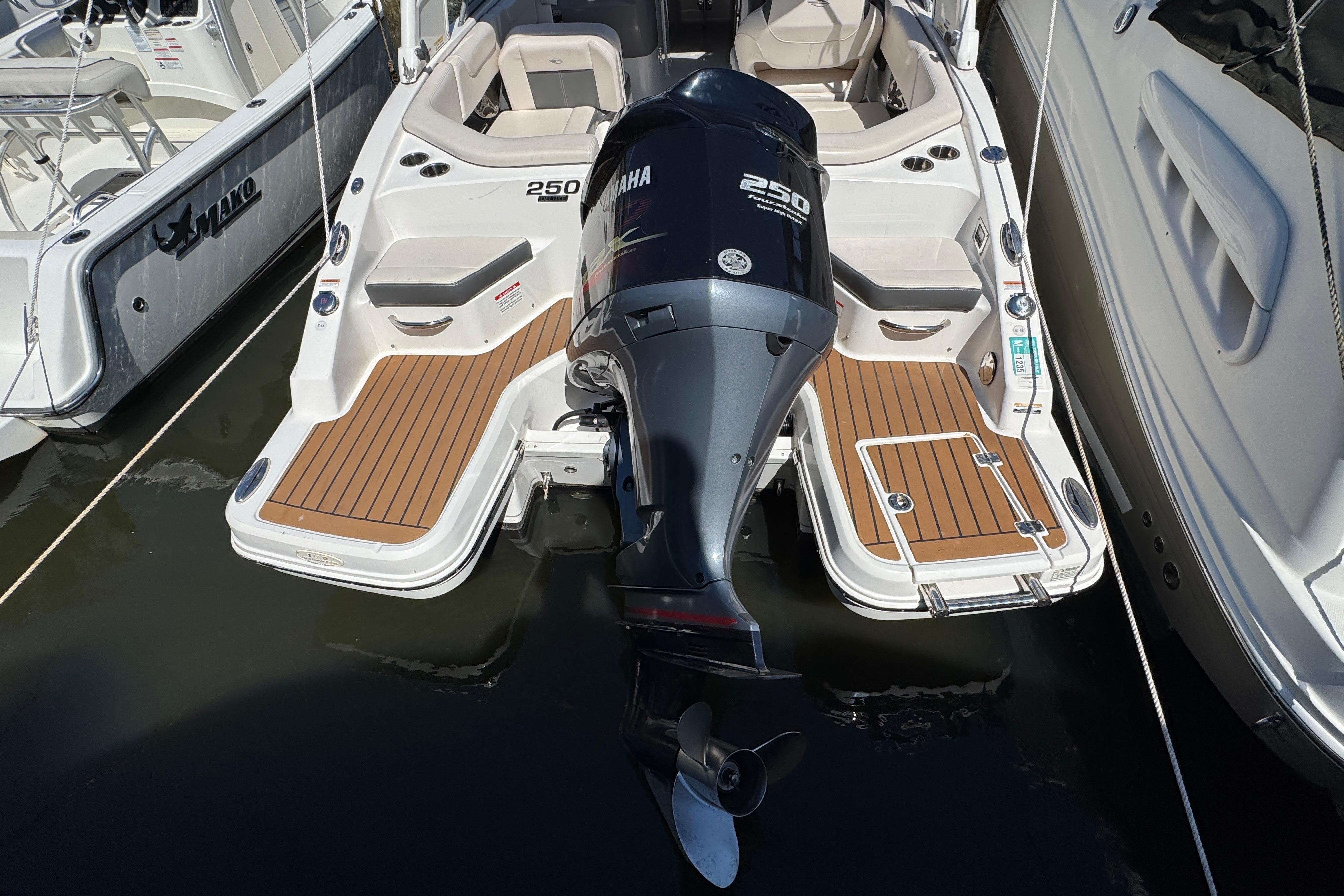 2018 Chaparral 250 Suncoast boat with Yamaha outboard engine, docked at marina.