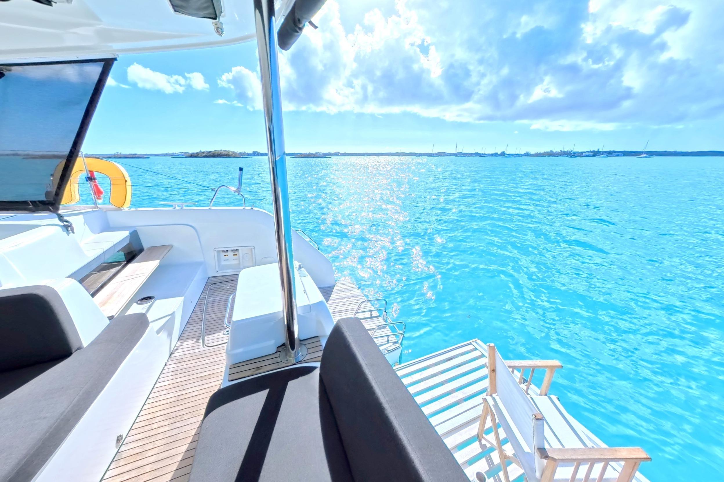 Lagoon 50 Yacht 2023 on blue water with sun deck.