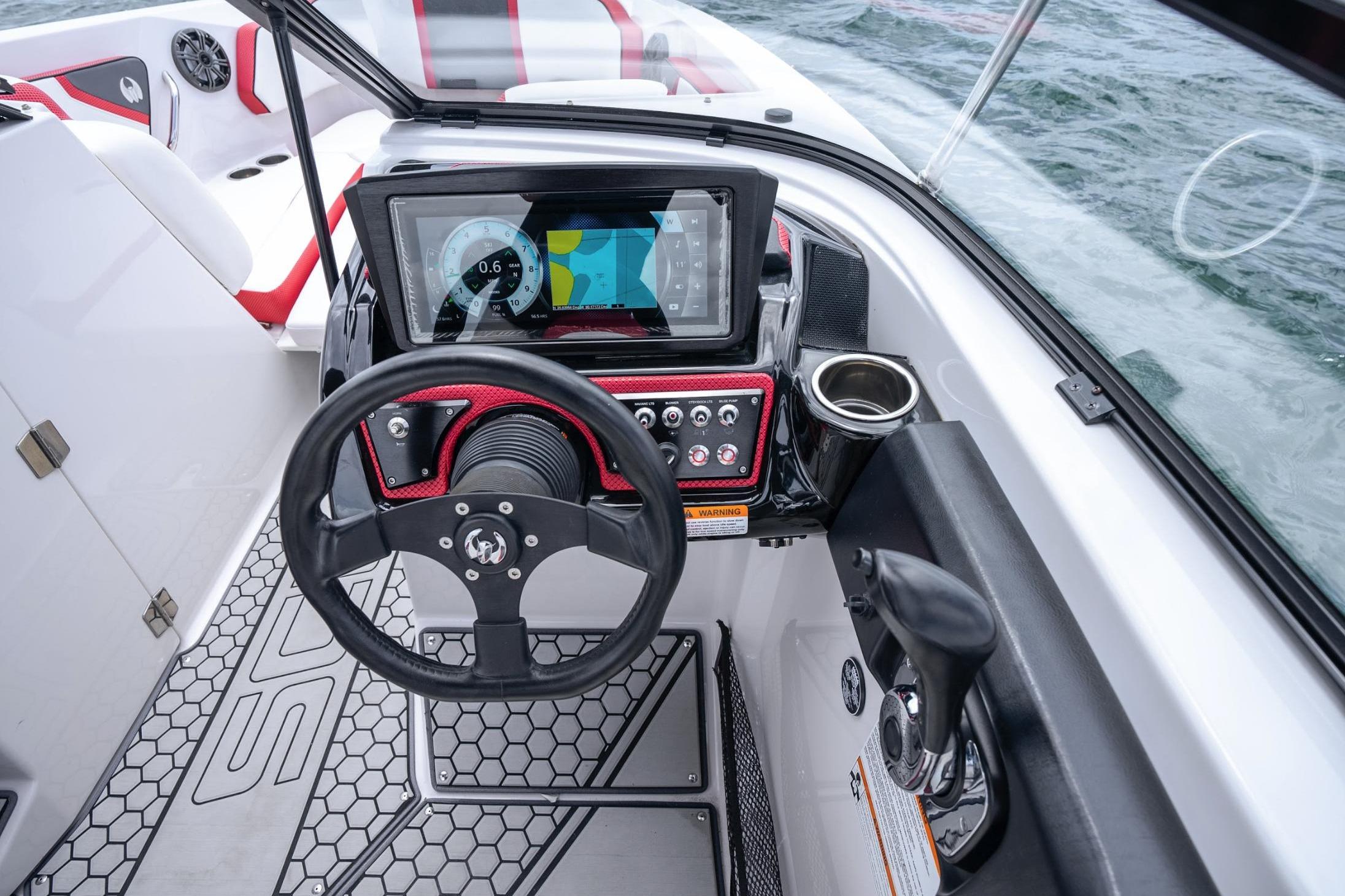 Cockpit of 2017 Scarab 255 H.O. Impulse boat with steering wheel and control panel.