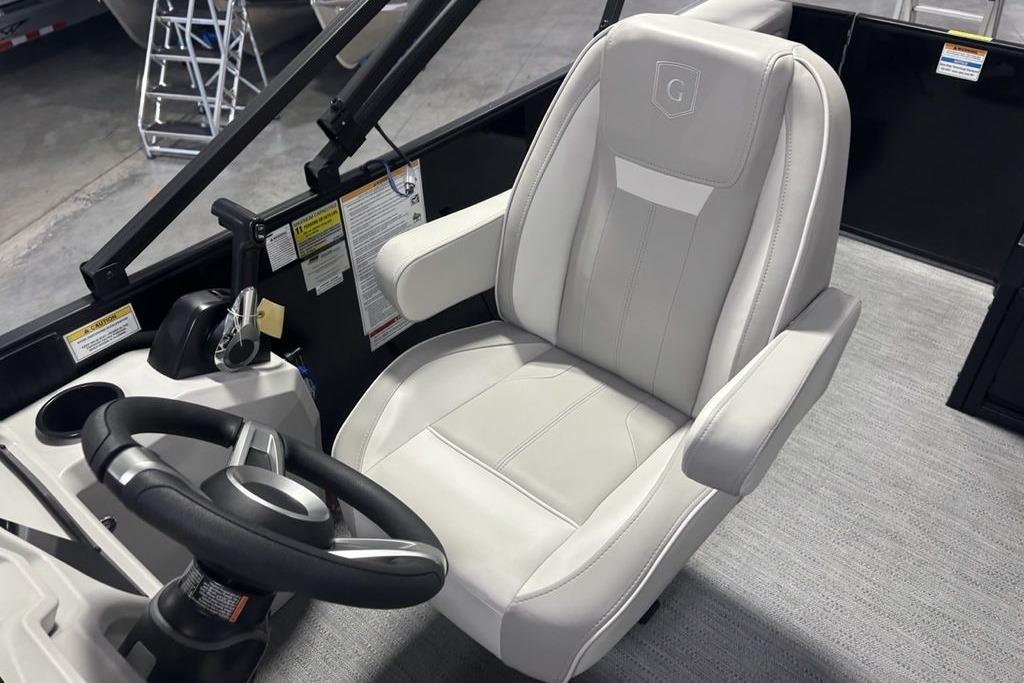 Captain's chair and steering wheel of 2026 Godfrey Xperience 2086 SFLX boat.