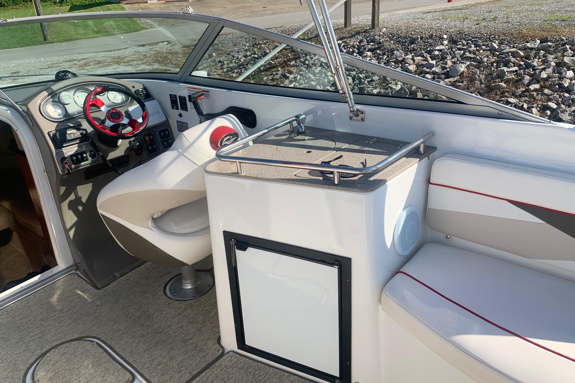 Interior of a 2006 Rinker 282 Captiva Cuddy boat with steering wheel and seating.