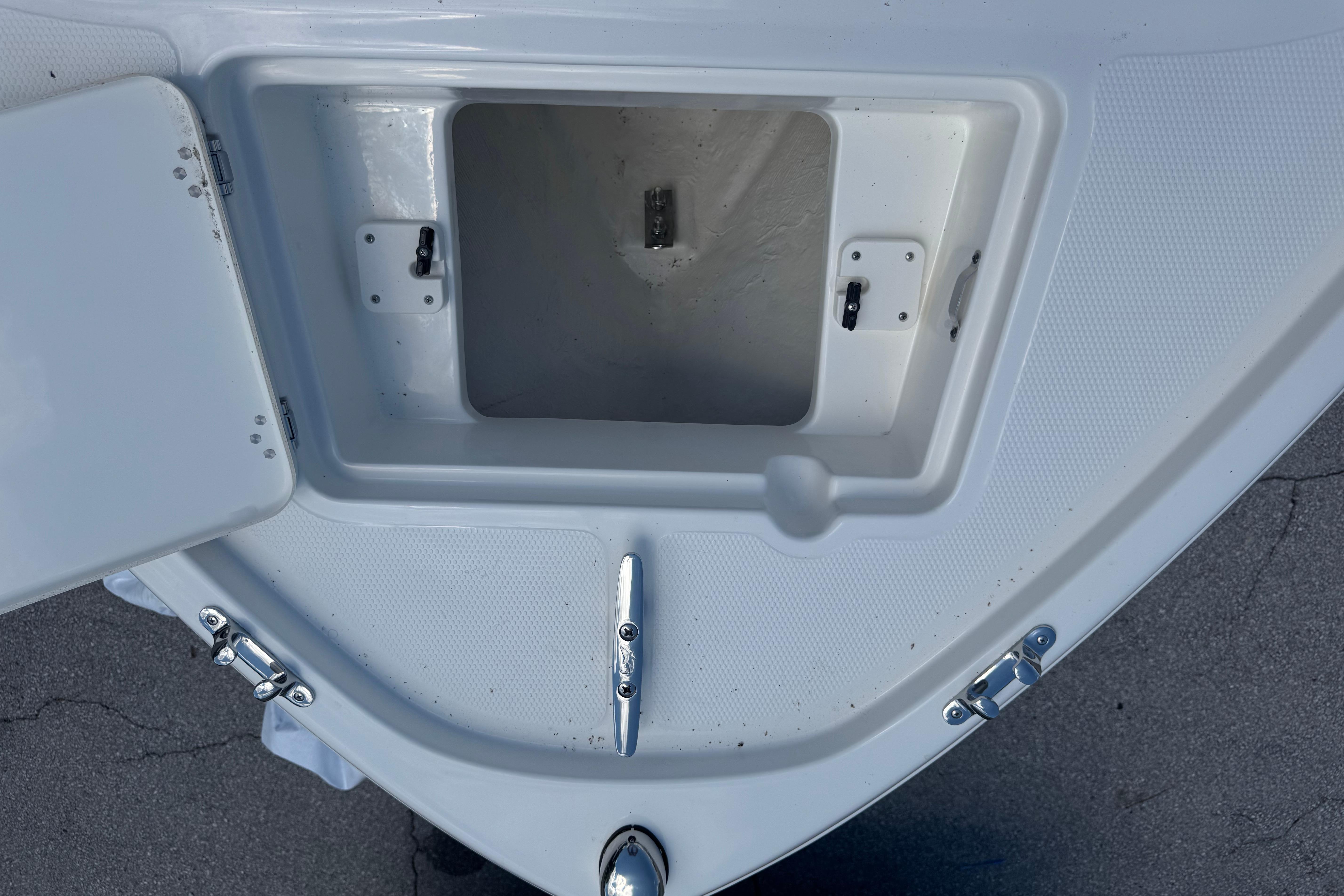 Open storage compartment on 2026 Mako 214 Center Console boat deck.