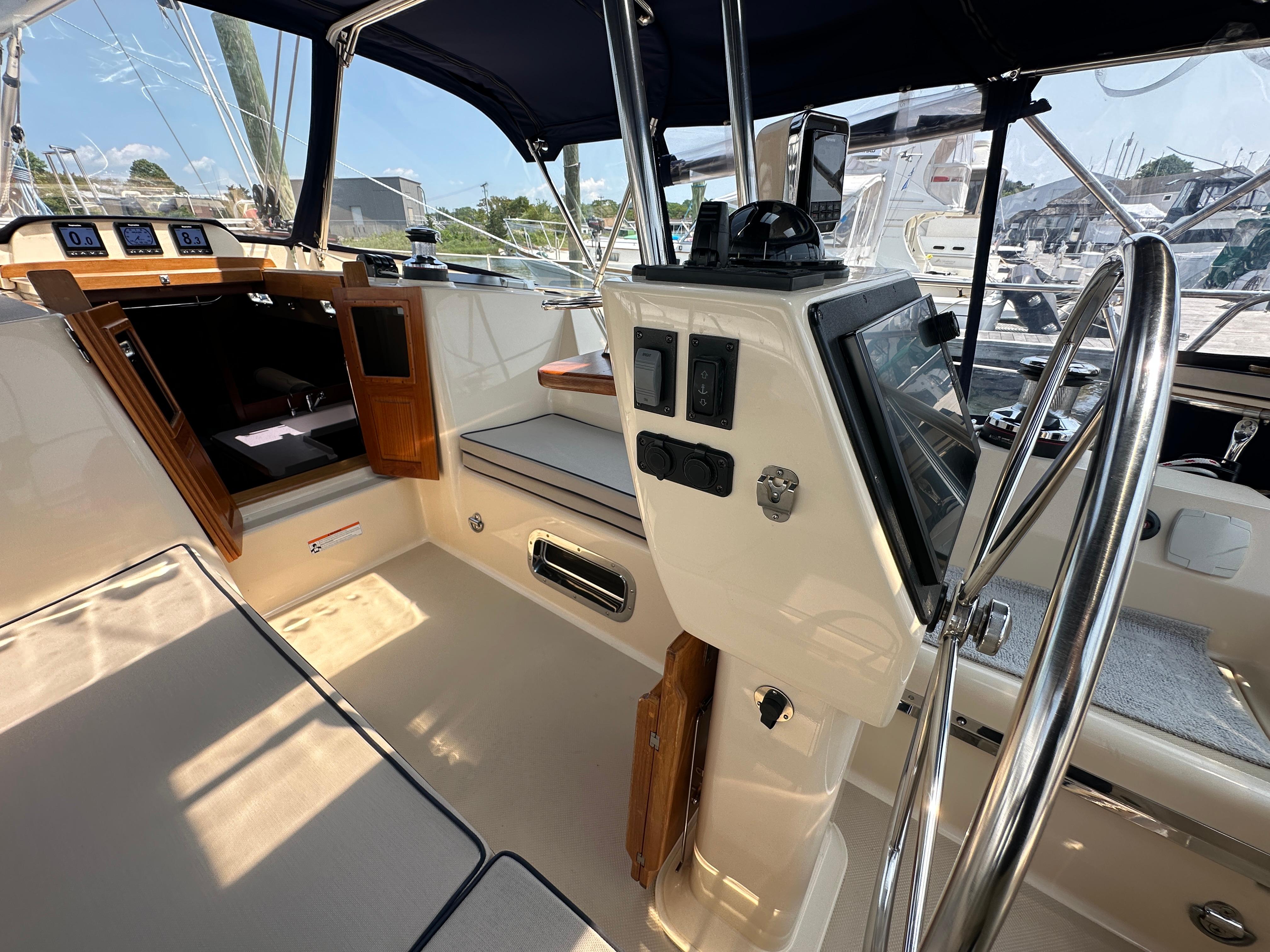 2021 Island Packet 439 yacht cockpit with navigation controls and seating area.