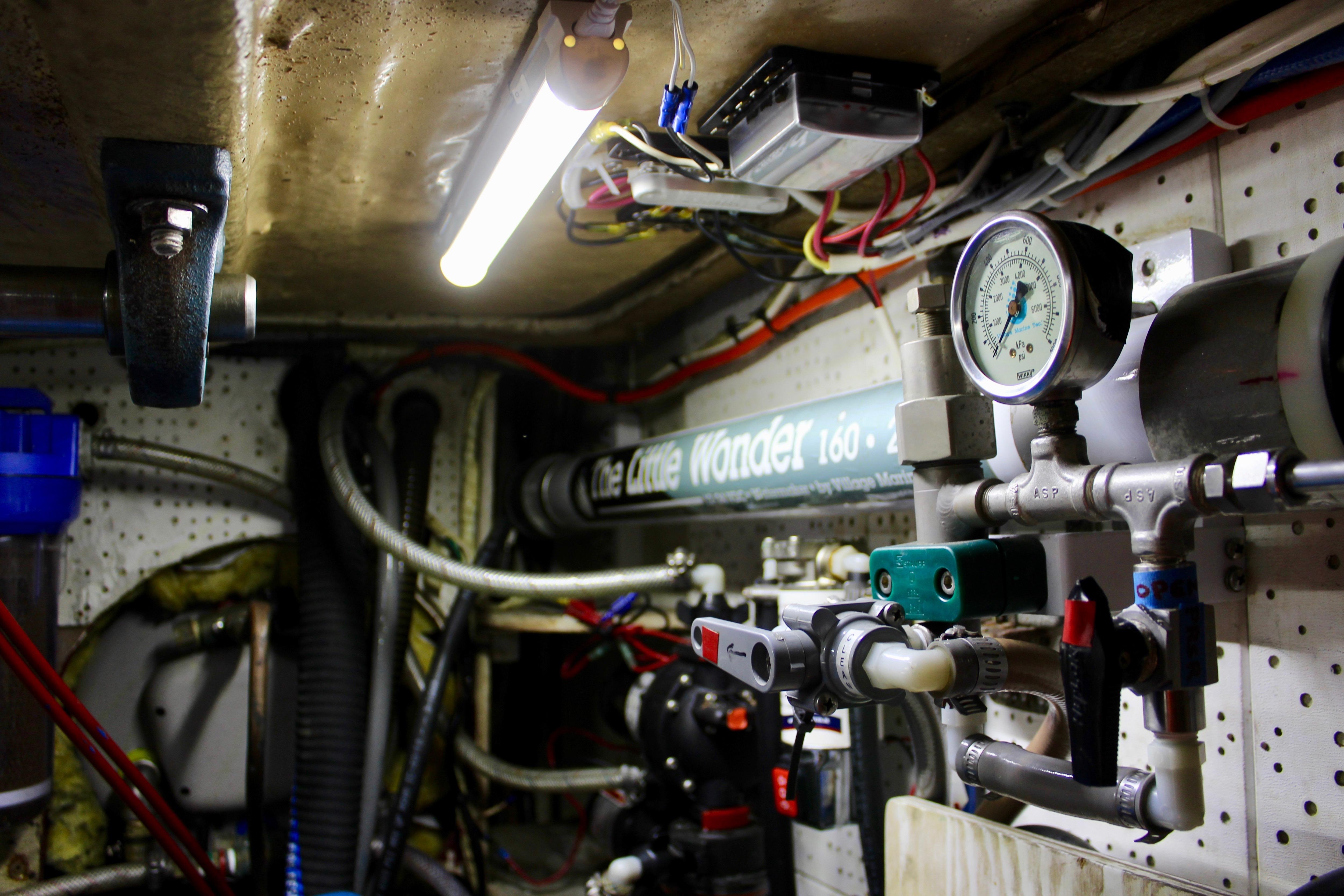 Engine room of a 1981 Kelly Peterson 46 yacht with gauges and pipes.