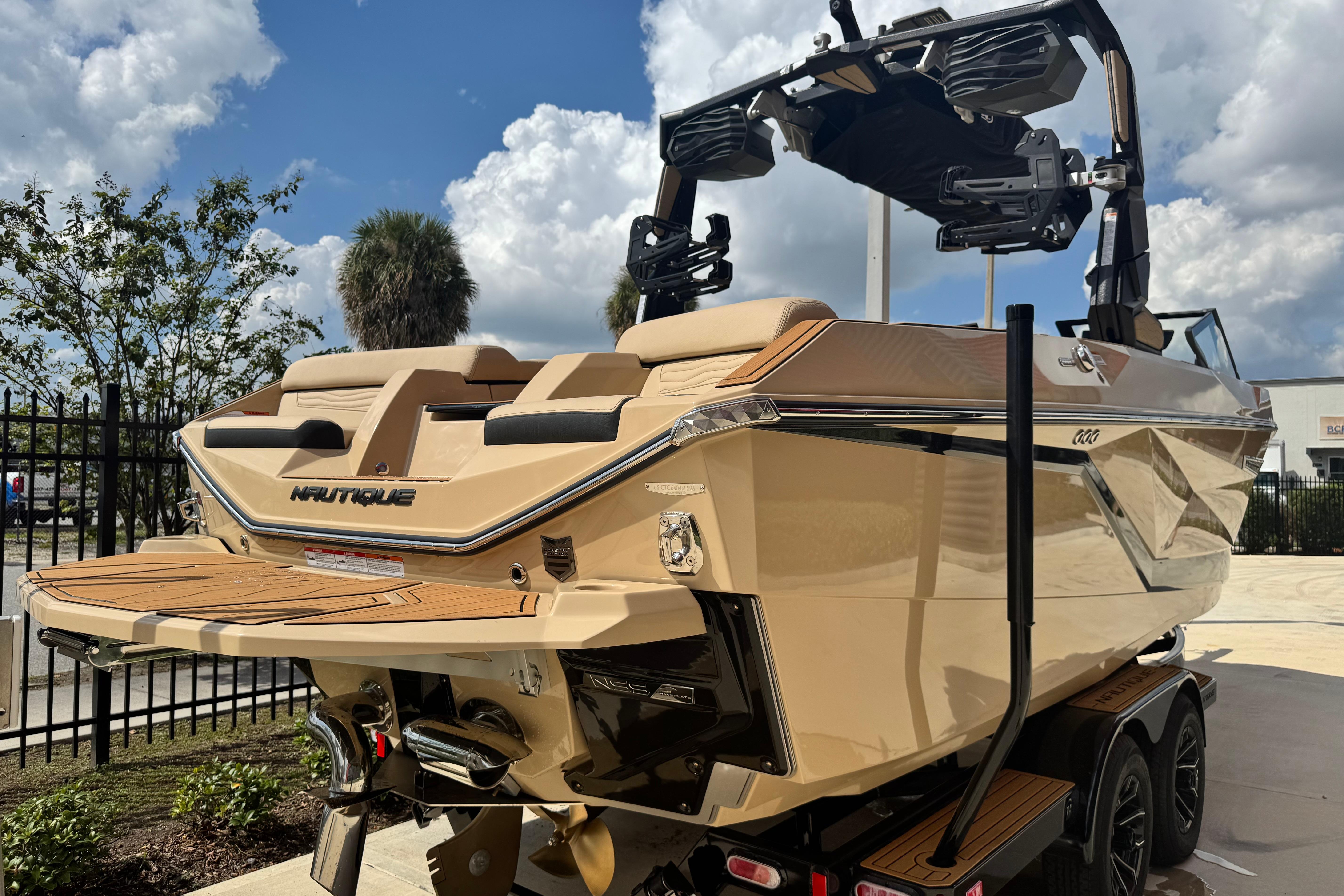 2026 Nautique Super Air Nautique G23 Paragon boat, beige exterior, parked outdoors.