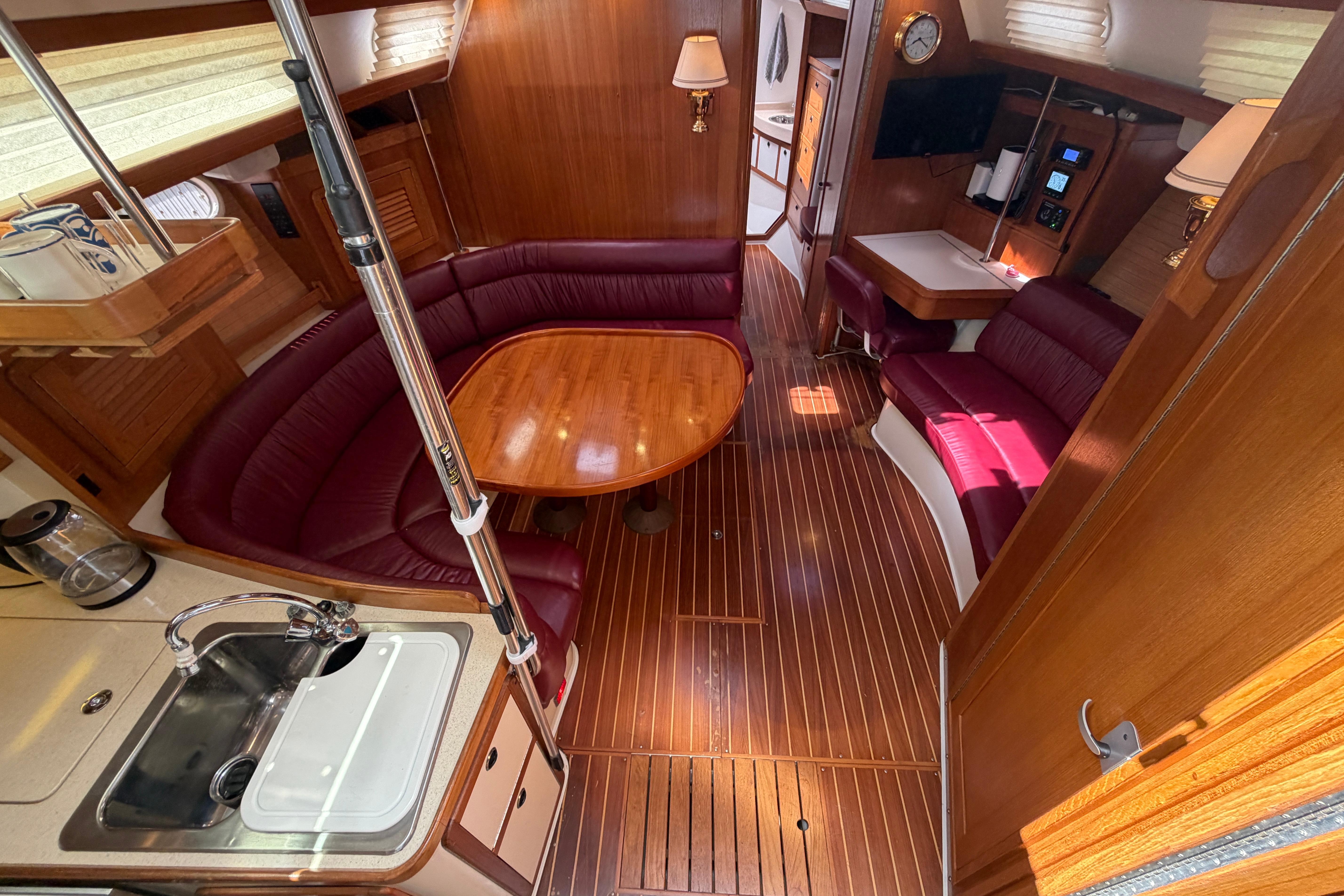 Interior of 2001 Catalina 42 MkII yacht with wood finish and plush seating.