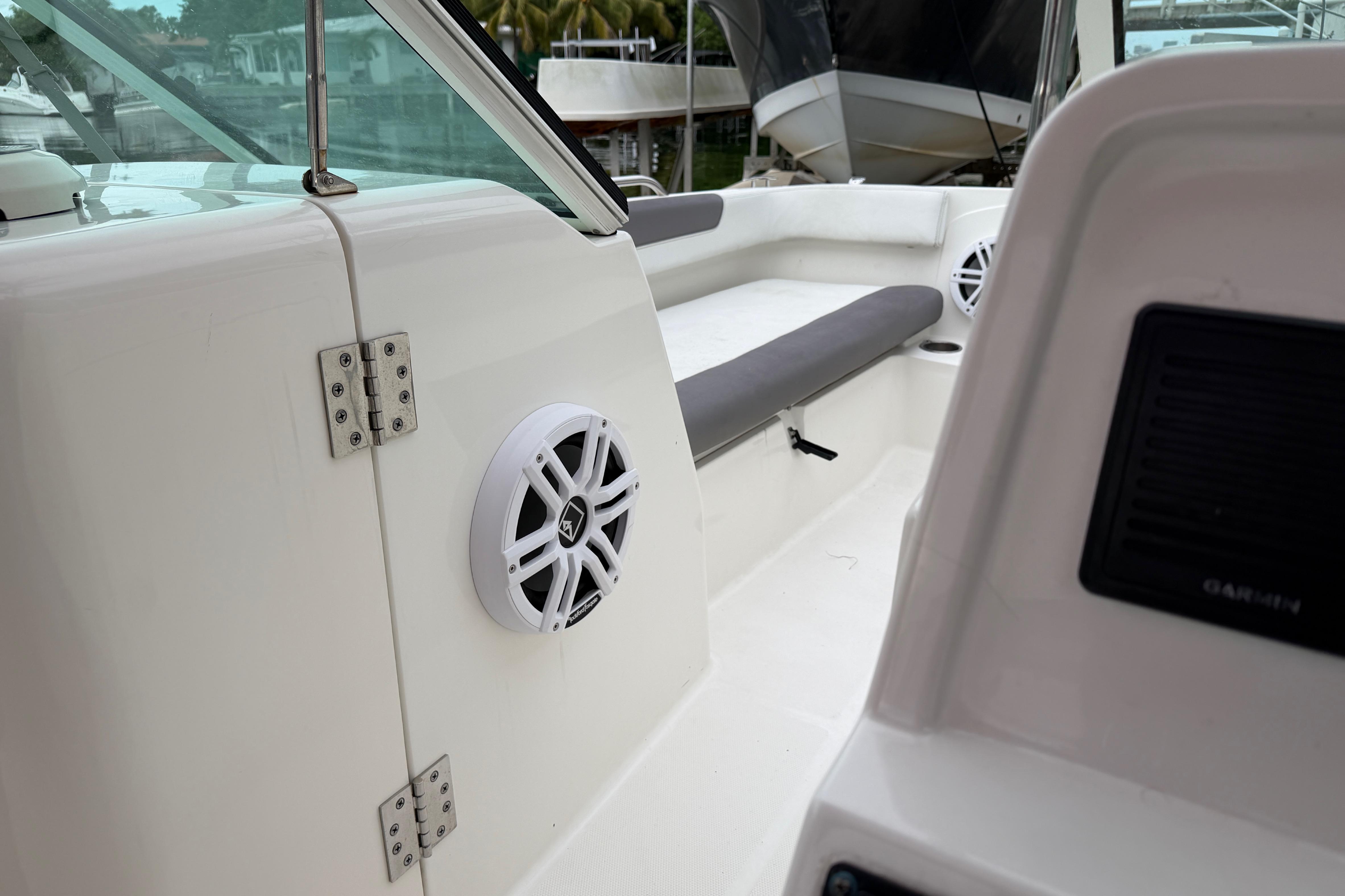 2019 World Cat 230 DC boat interior with speakers and seating area.