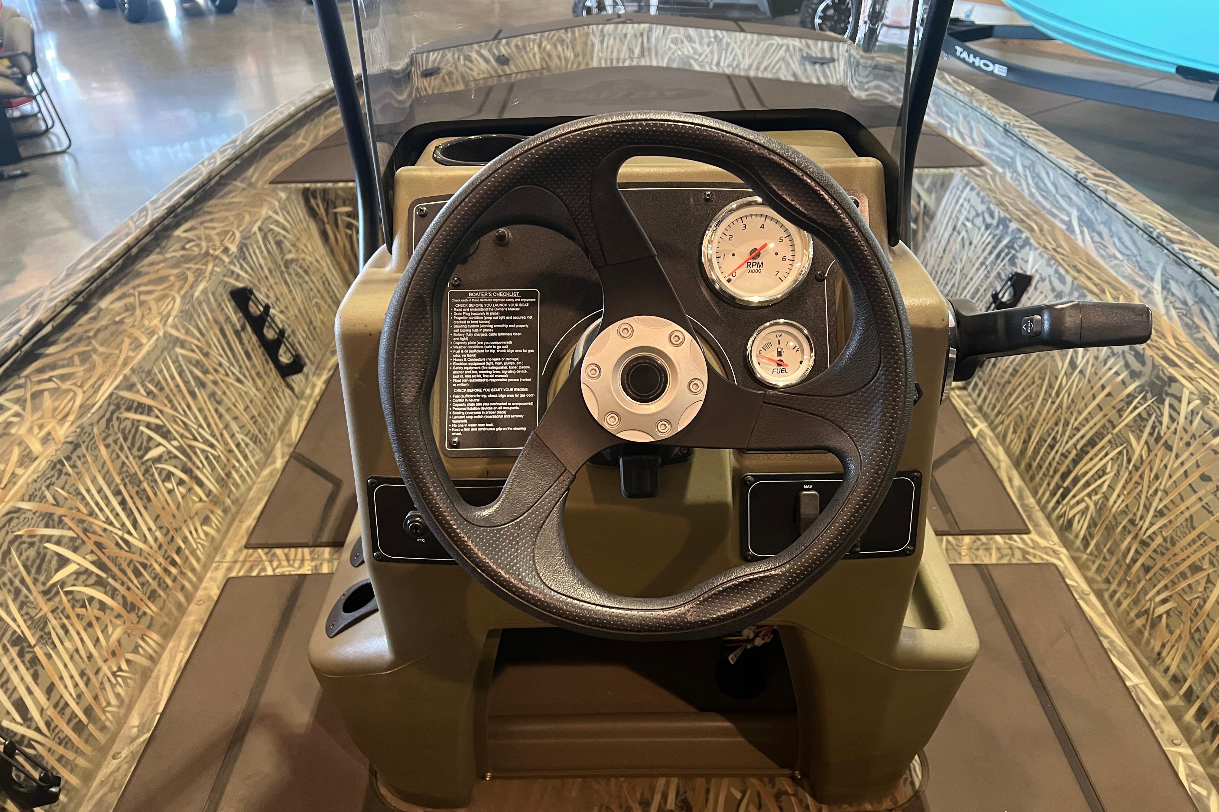 Steering console of 2026 Tracker Grizzly 1860 CC boat with camo design.