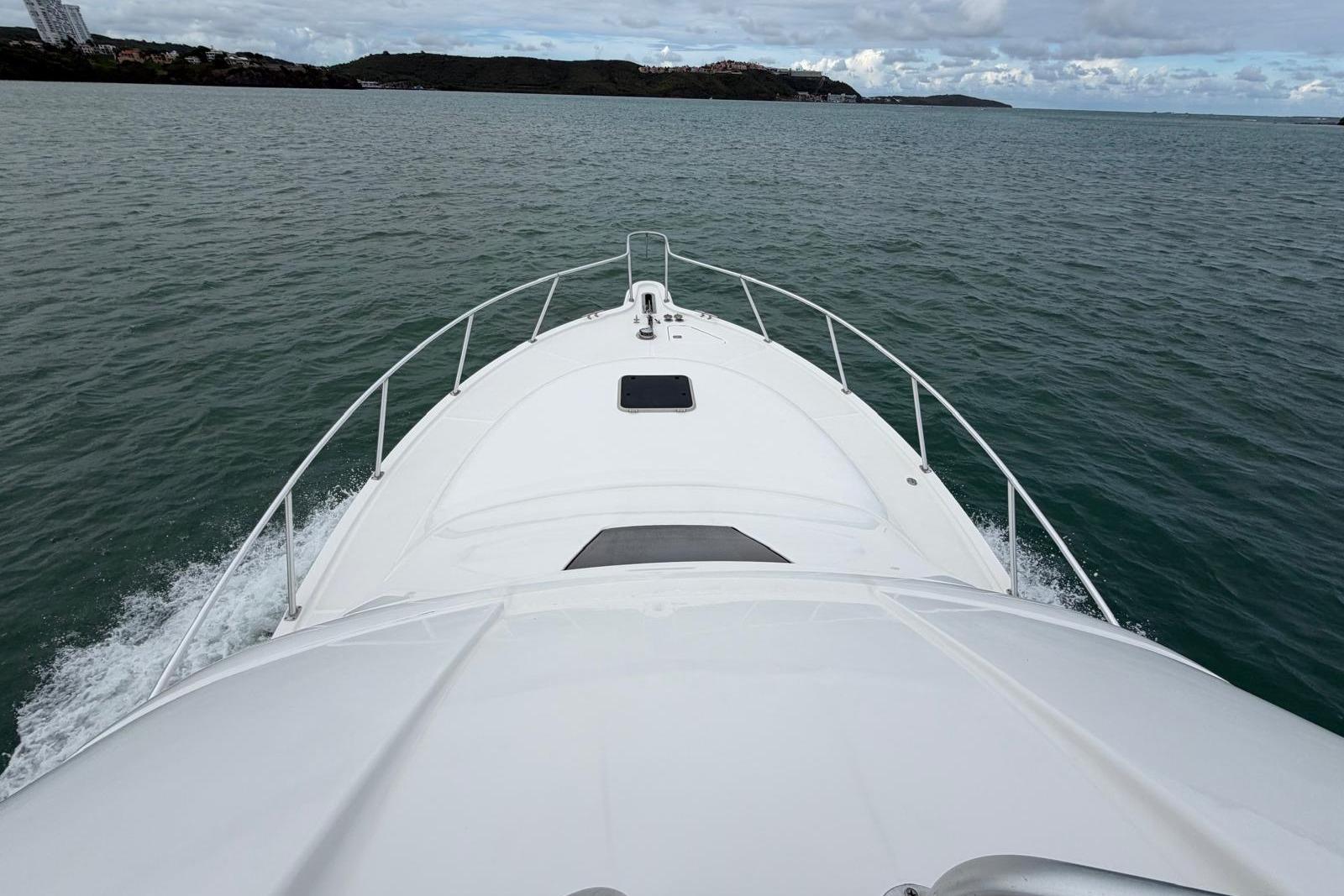 2007 Tiara Yachts 3900 Convertible cruising on open water, view from the bow.