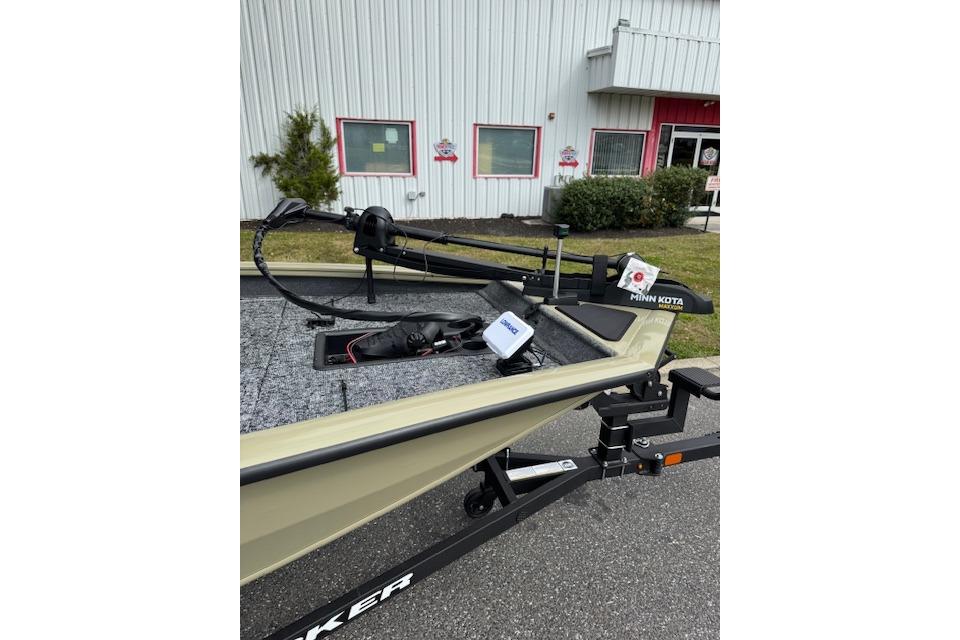 2026 Tracker Pro Team 190 boat with Minn Kota trolling motor, parked outside a building.