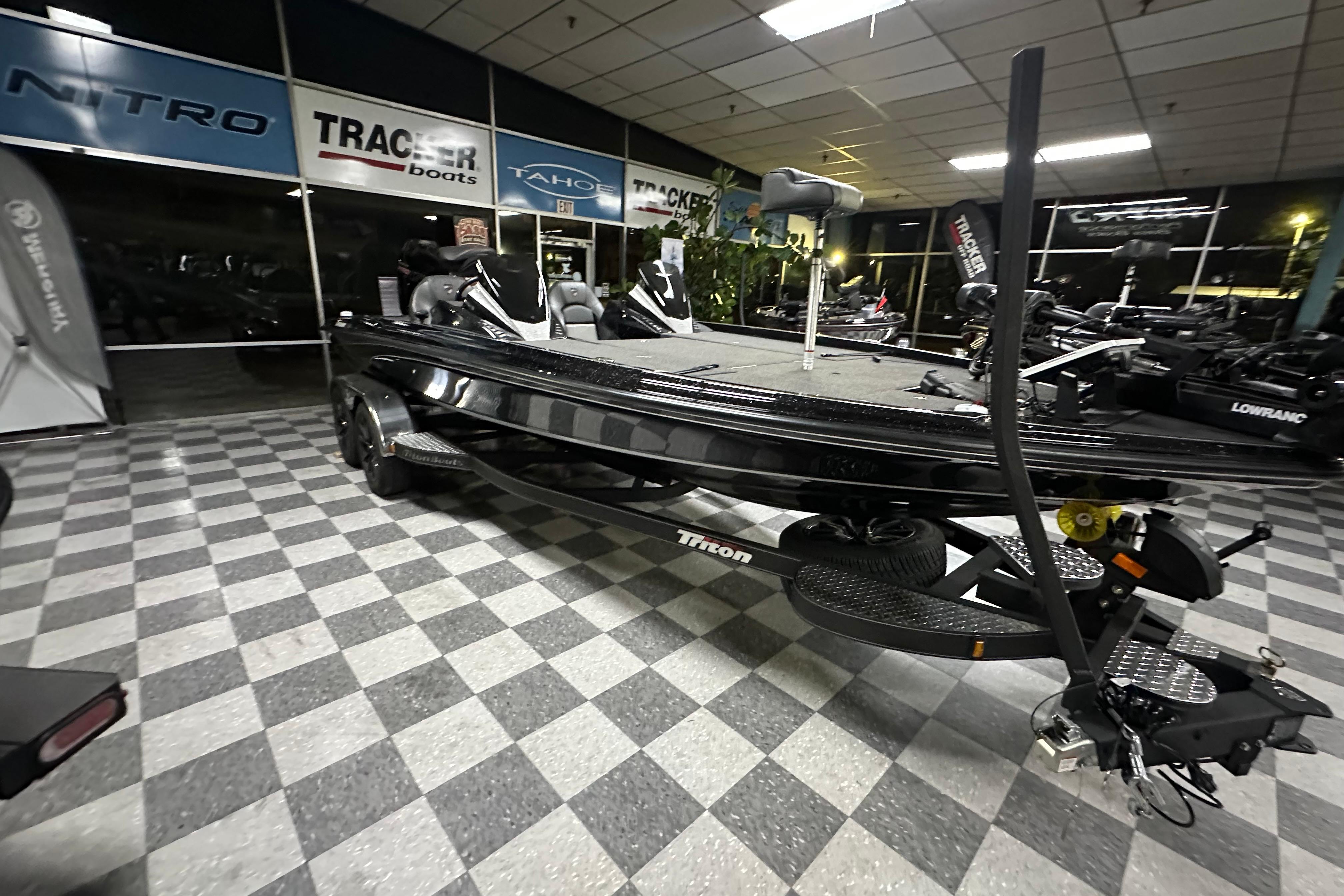 2025 Triton 21XP Patriot boat displayed in showroom with checkered flooring.