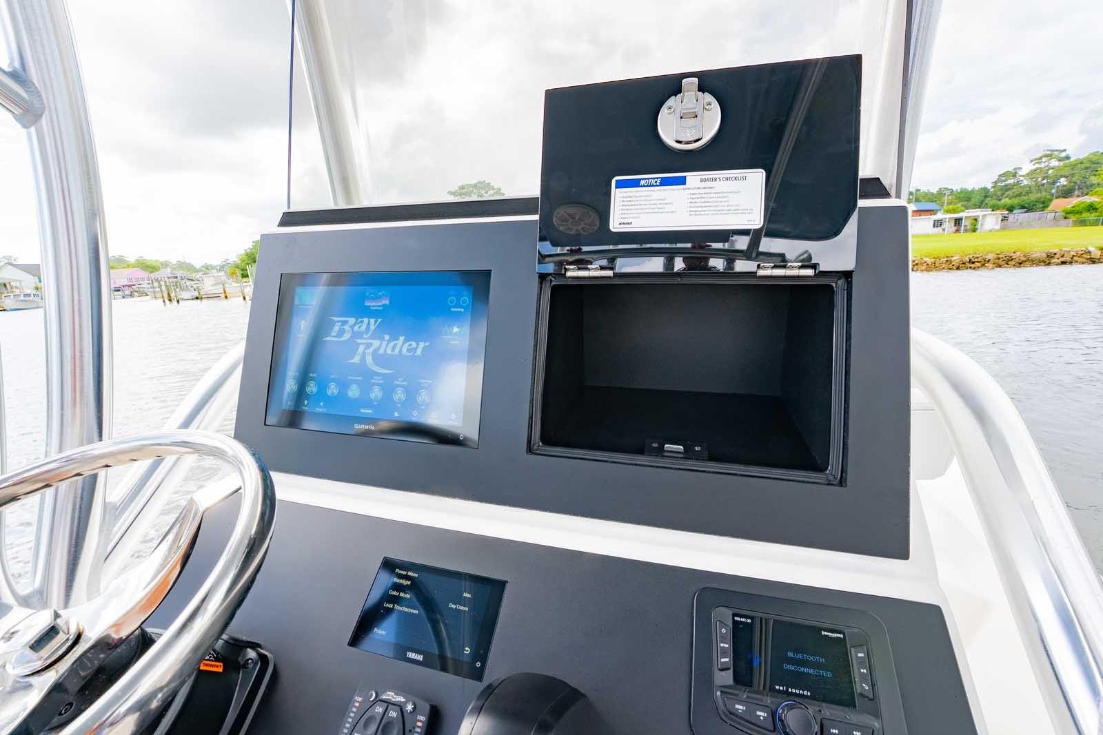 2026 Bay Rider 219 Bay boat dashboard with touchscreen display and storage compartment.