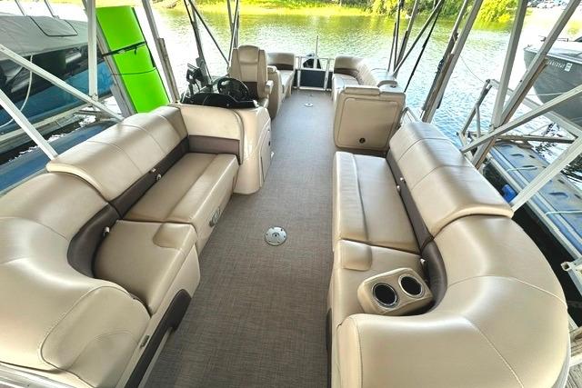 2019 Sun Tracker Party Barge 22 XP3 interior with beige seating and cup holders.
