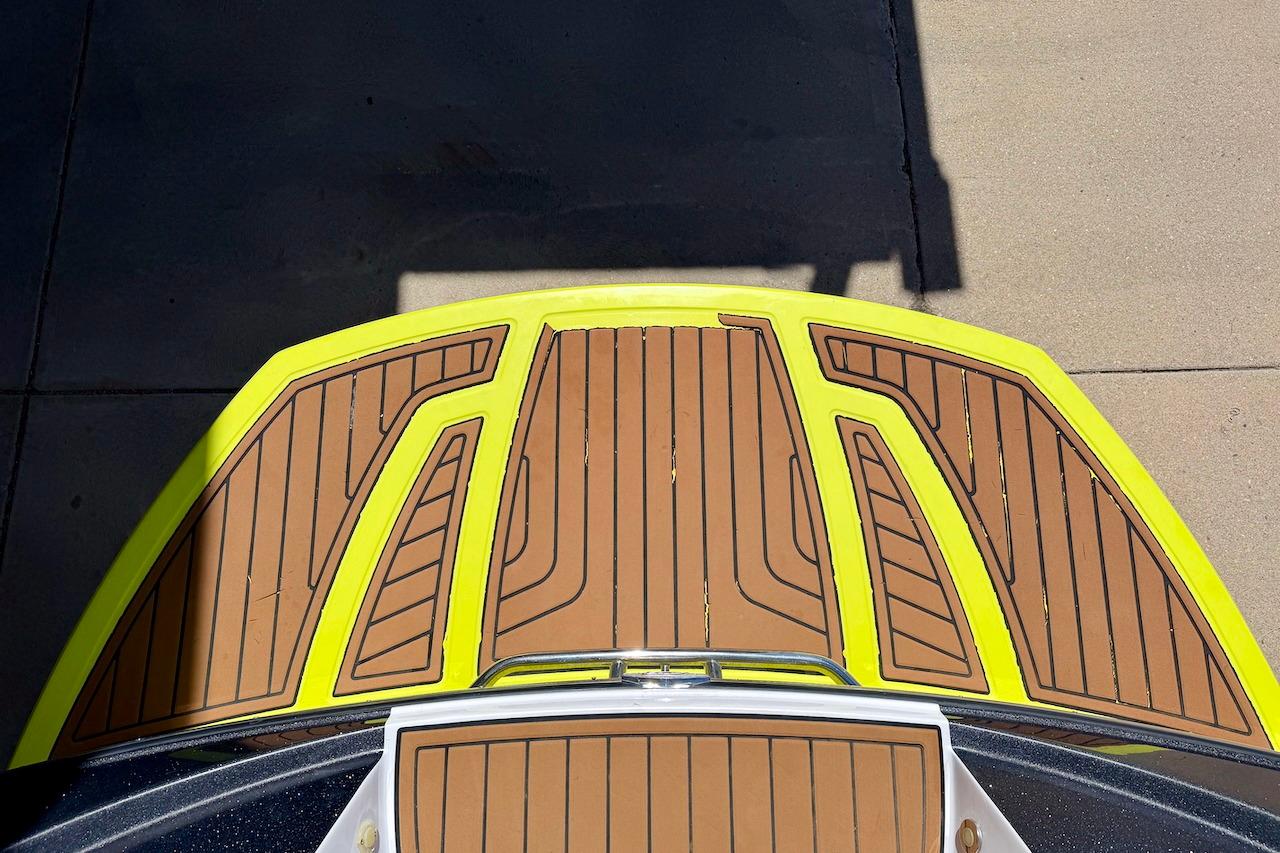 2014 Nautique Super Air Nautique G21 boat deck with yellow trim and brown panels.