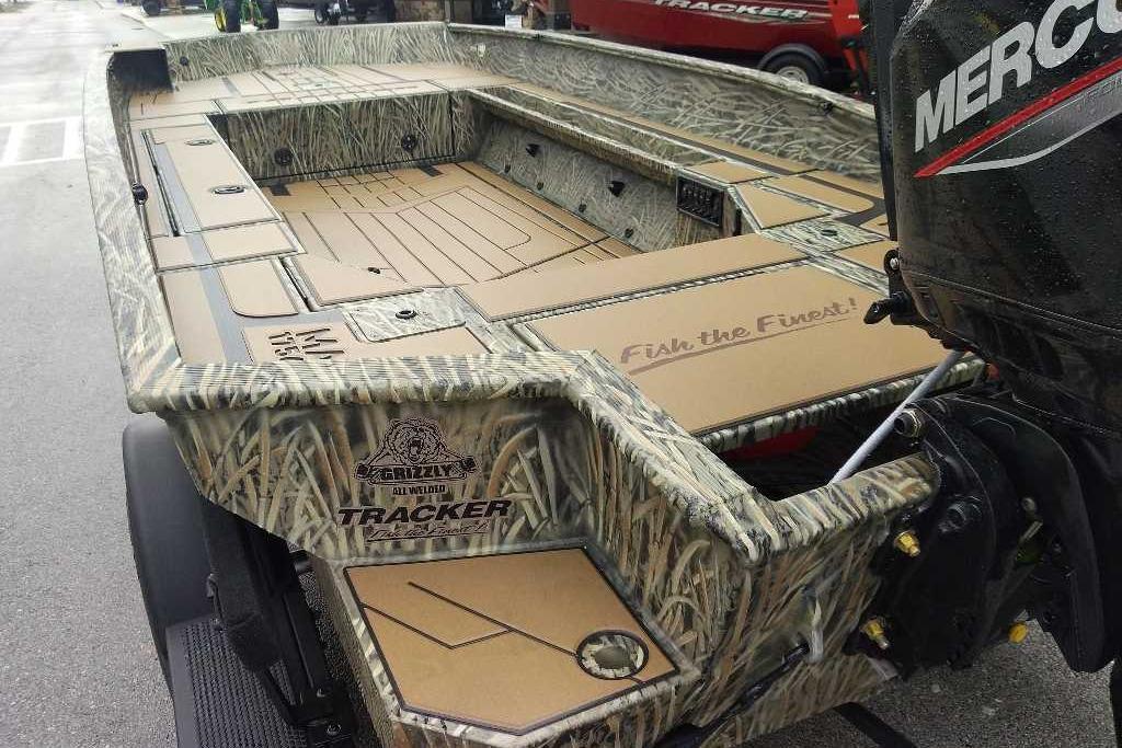 2026 Tracker Grizzly 1756 T Marsh boat with camouflage design and Mercury outboard motor.
