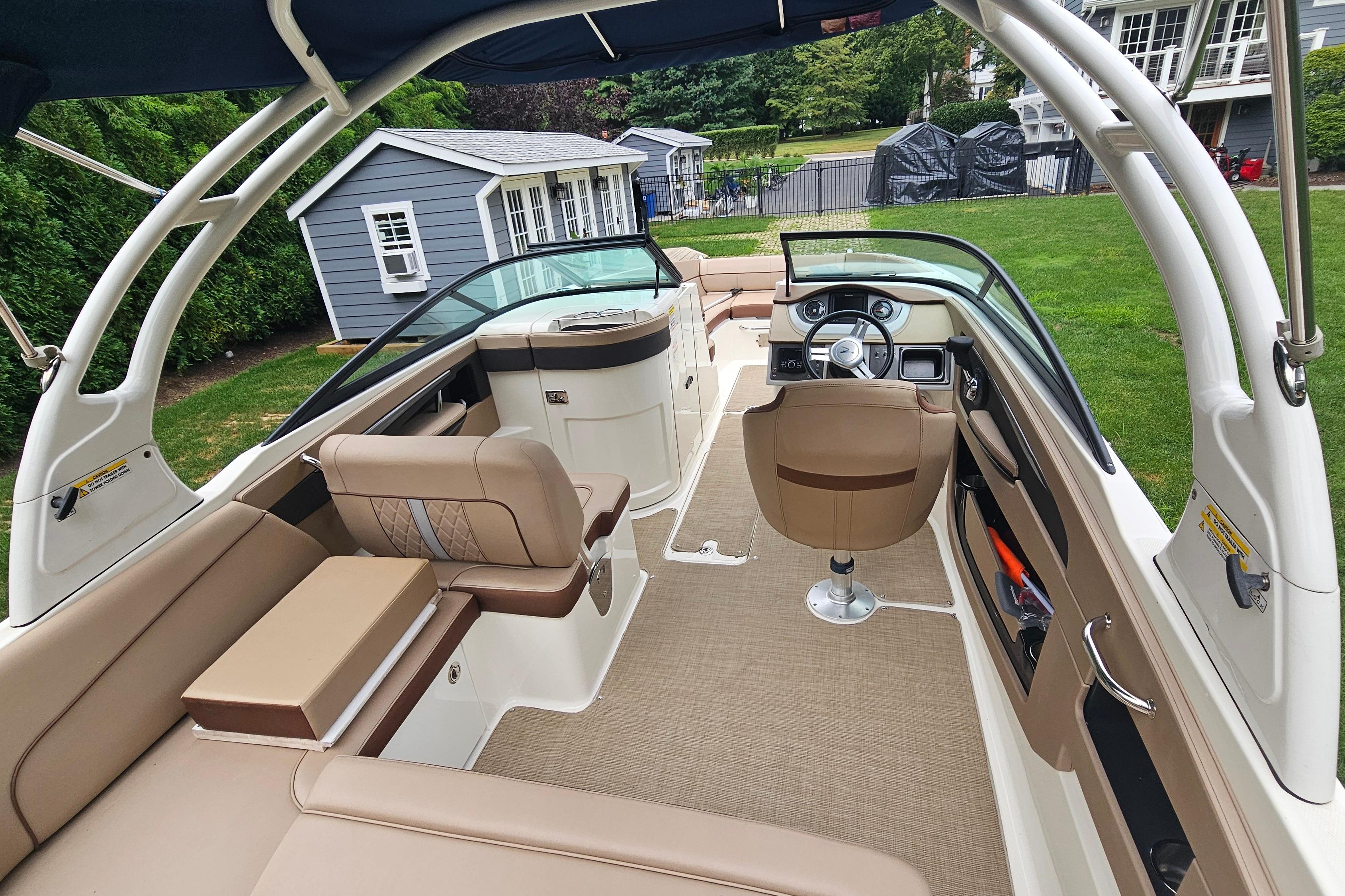 2017 Sea Ray SDX 240 Outboard boat interior with beige seating and modern dashboard.