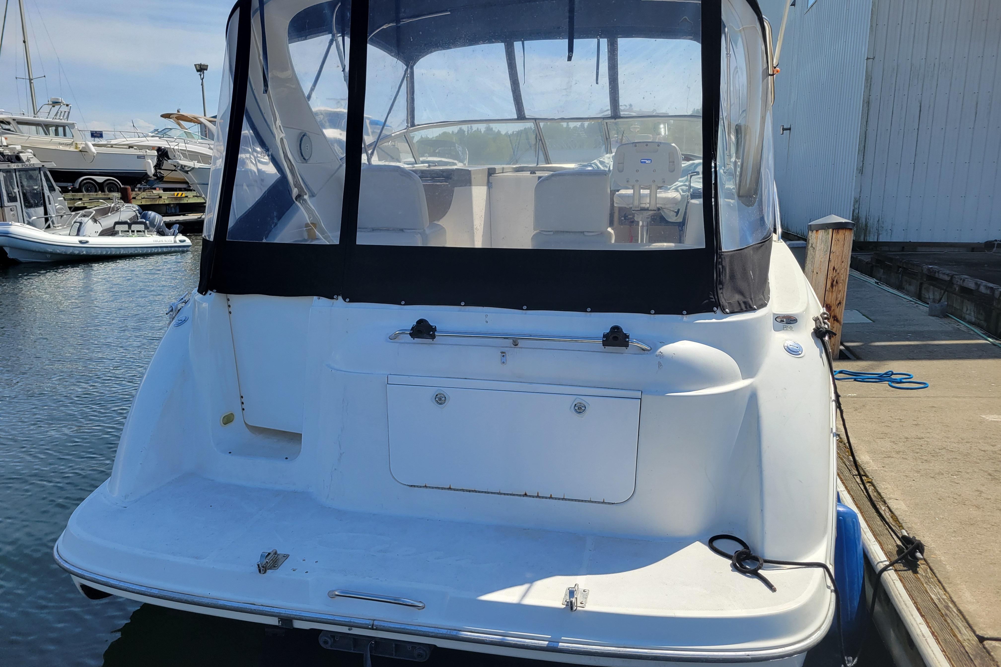 1999 Bayliner 3055 Ciera Sunbridge docked at marina, rear view.