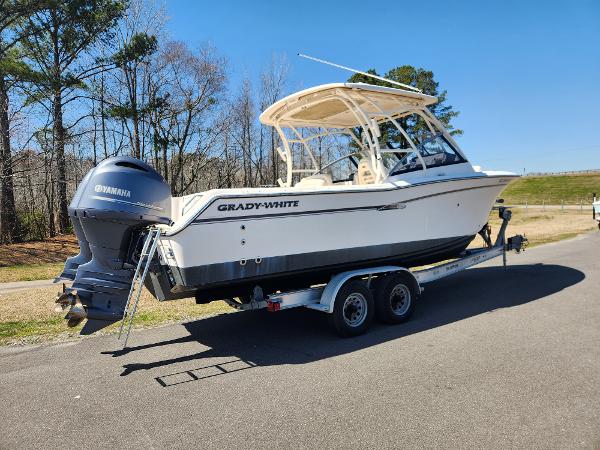 2015 Grady-White Freedom 275 boat on trailer, parked on road, clear sky background.