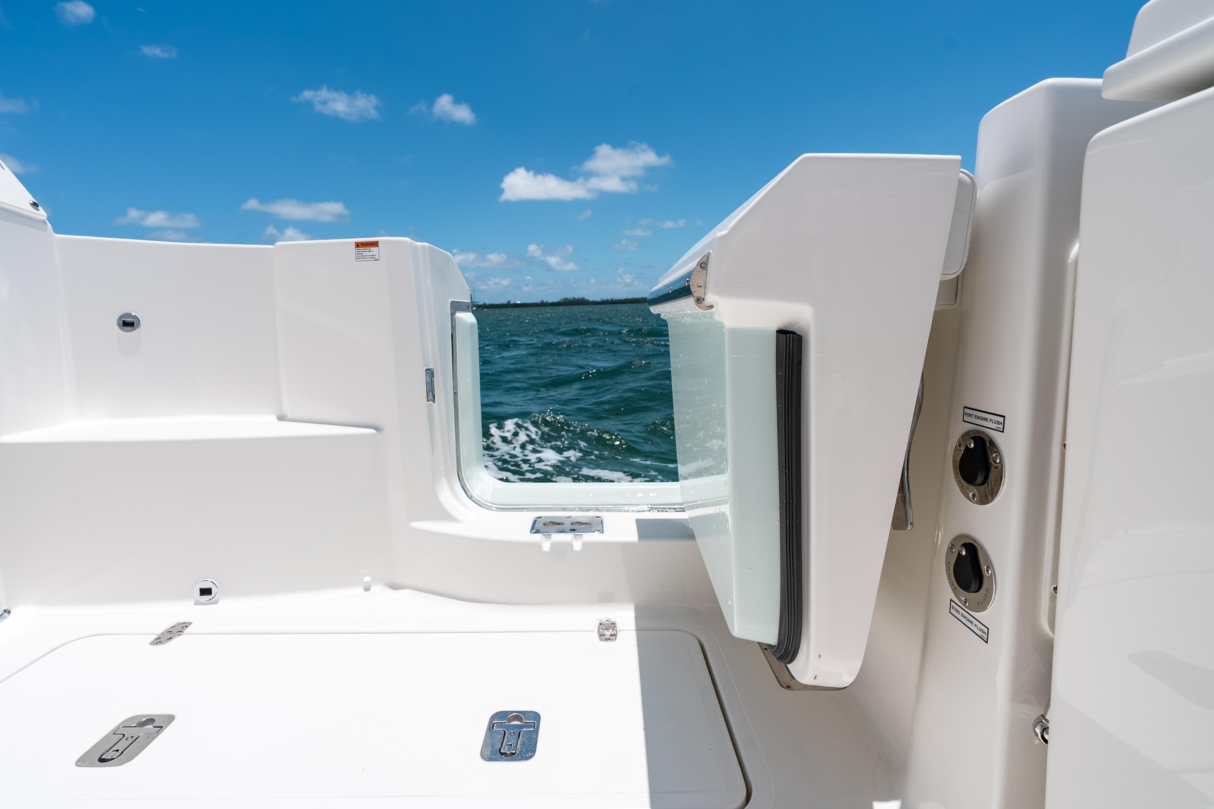 2026 Pursuit DC 326 Dual Console boat with open side door, ocean view.