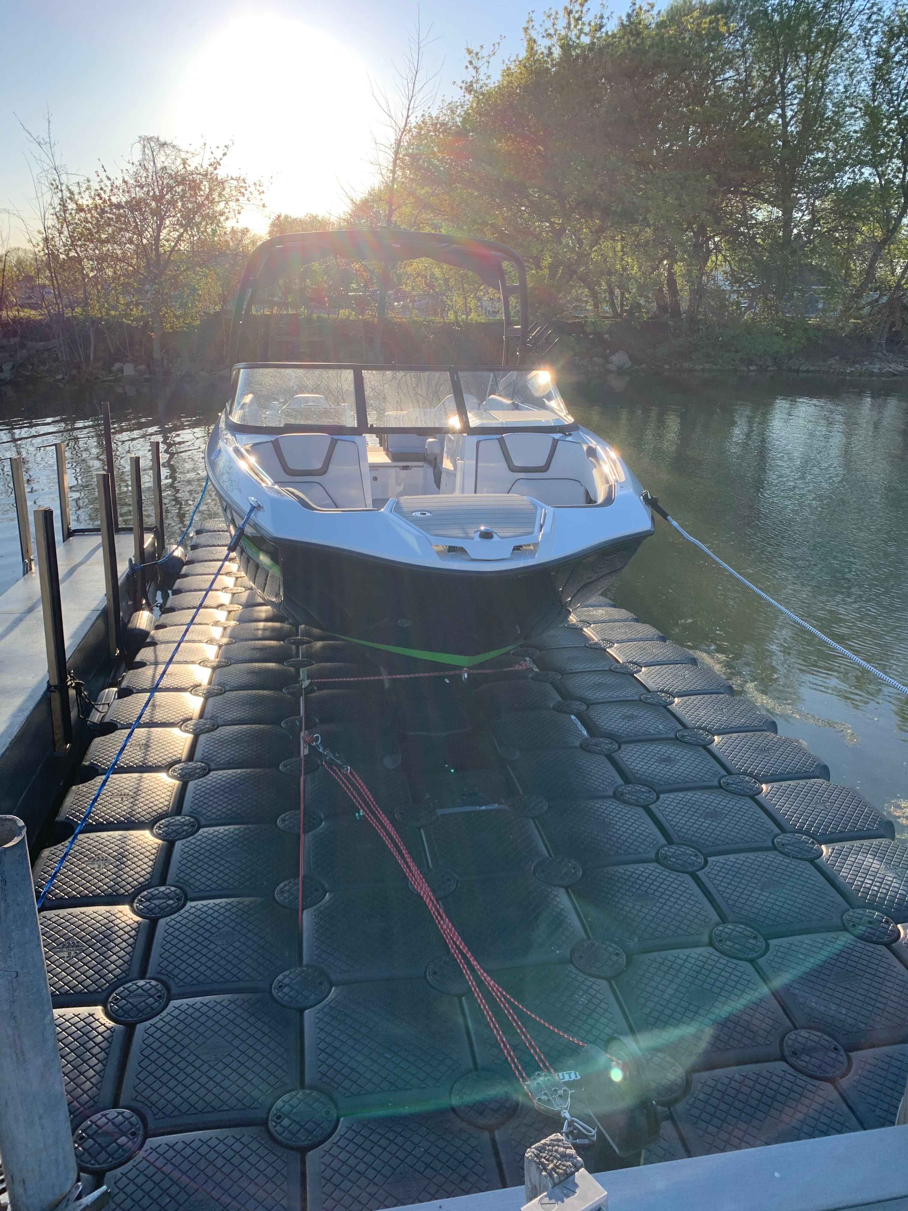 2021 Yamaha AR250 boat on floating dock at sunset.