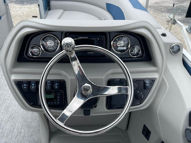 Steering console of 2025 Berkshire 22 RFX LE Tri-toon Pontoon with gauges and controls.