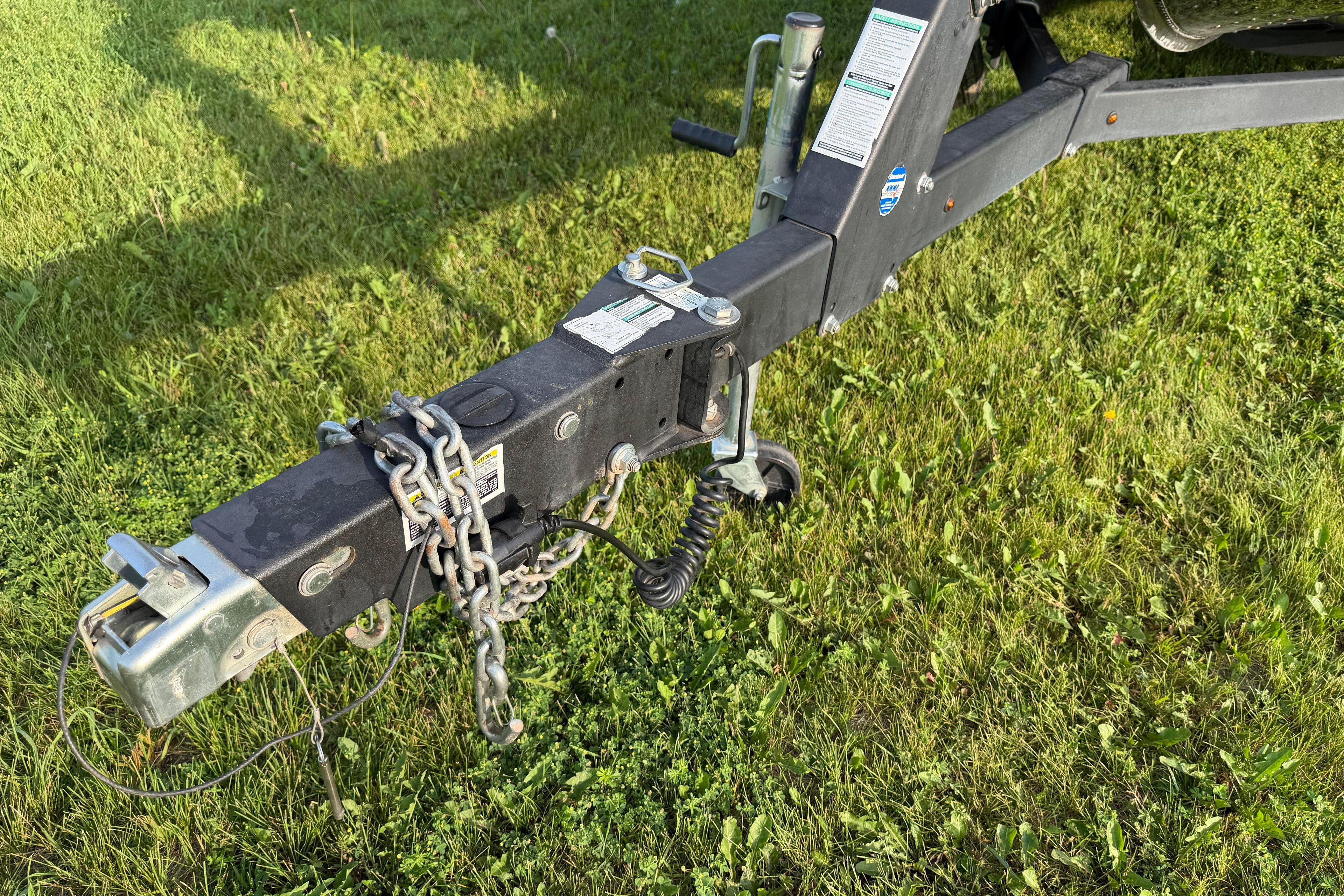 Trailer hitch of a 2019 Alumacraft Trophy 205 on grassy field.
