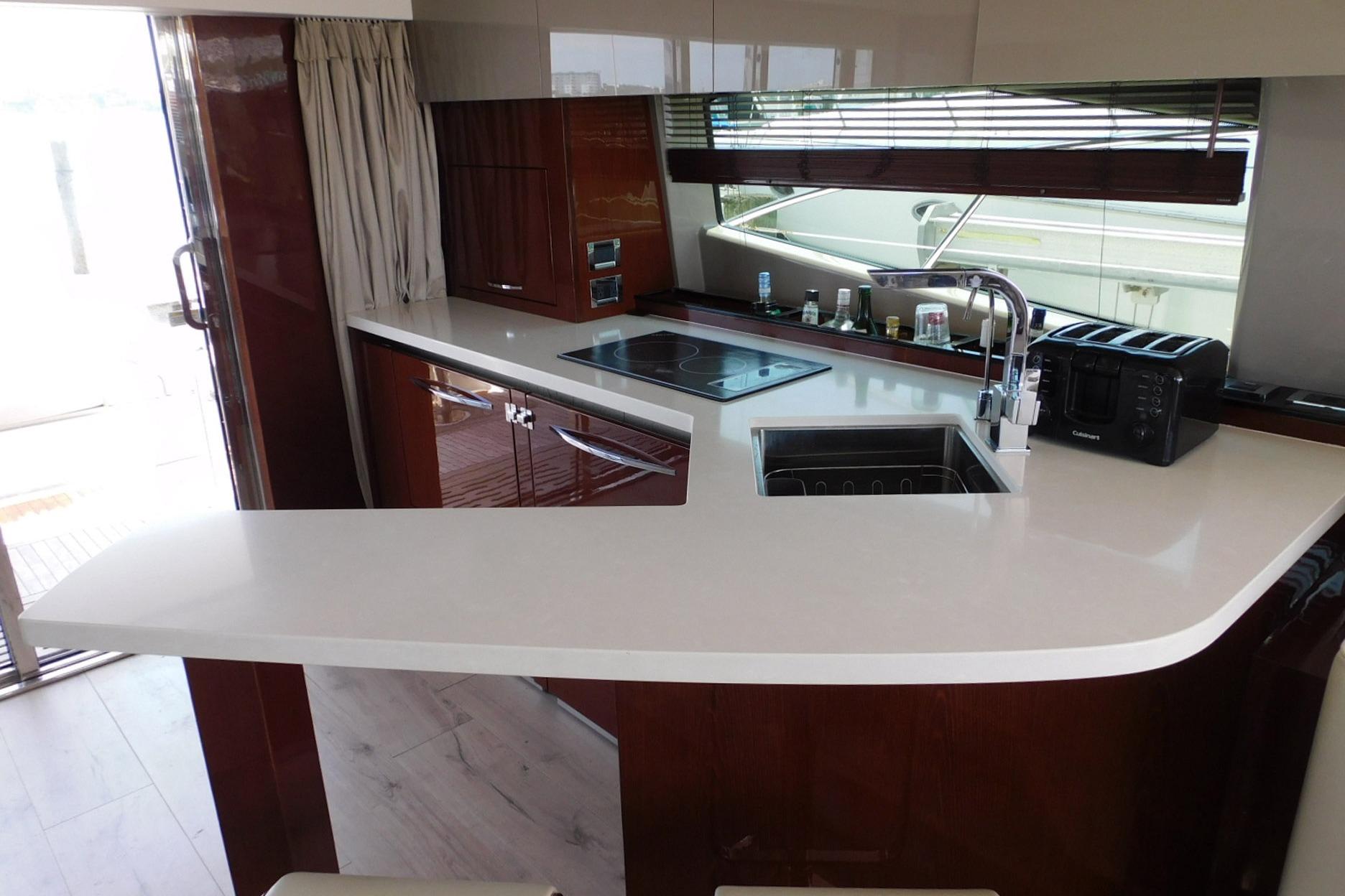 Luxurious kitchen interior of 2019 Sea Ray L550 yacht with modern appliances and sleek design.