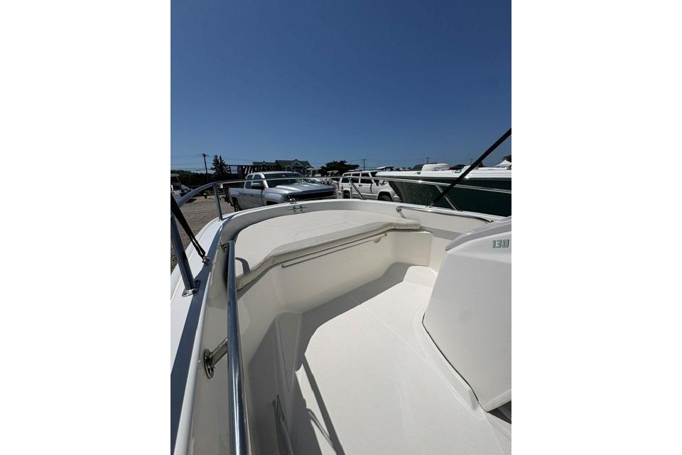 2024 Boston Whaler 130 Super Sport boat interior with sleek design and stainless steel railings.