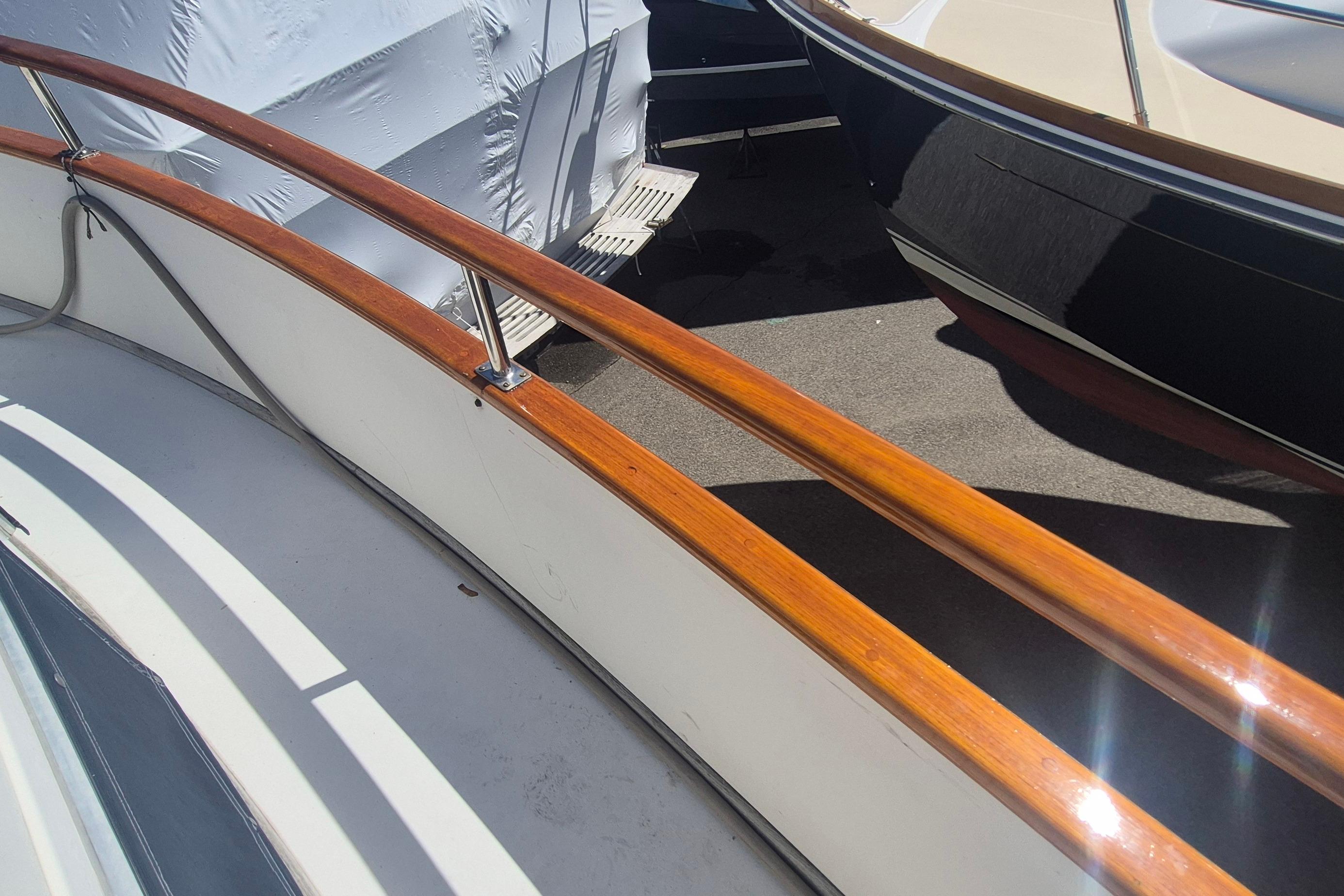 1983 Grand Banks 42 Motoryacht with polished wooden railings in a marina setting.