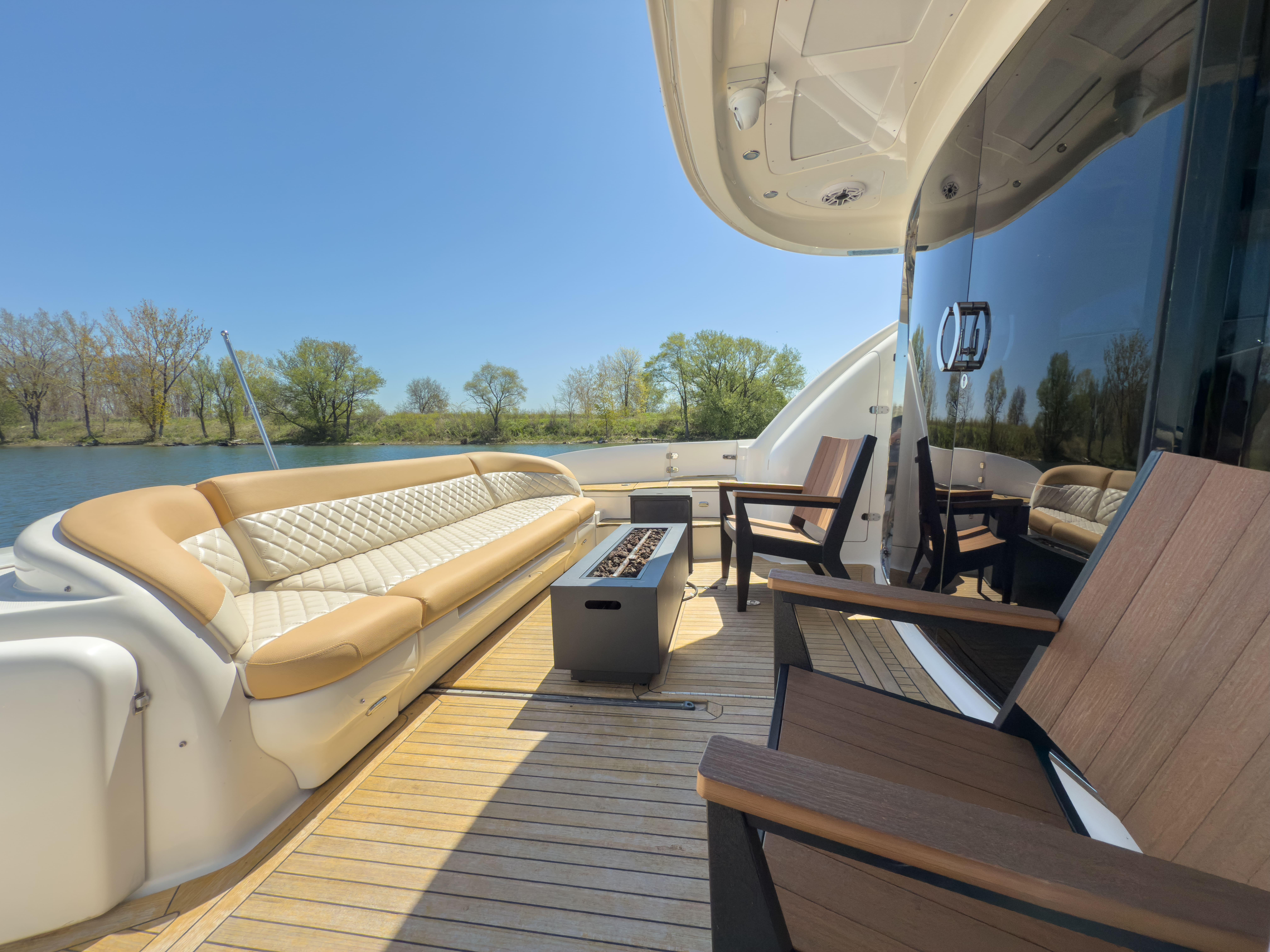 Luxurious 2003 Sea Ray 680 Sun Sport yacht deck with seating and scenic river view.