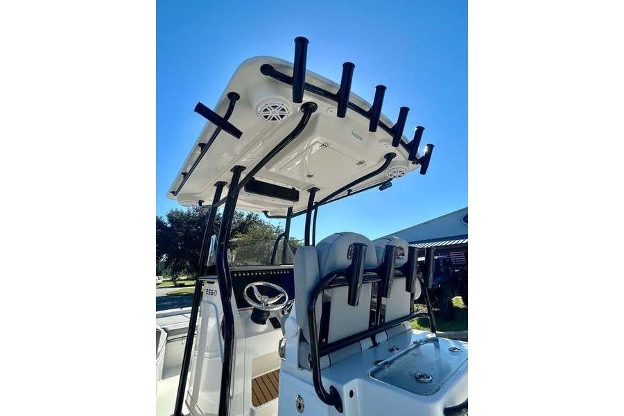 2026 Ranger 2360 Bay boat with T-top and rod holders under clear blue sky.