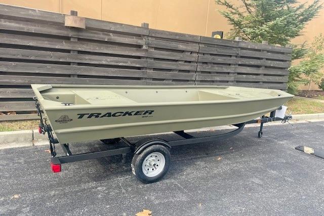 2026 Tracker Grizzly 1648 Utility boat on trailer, parked outdoors.