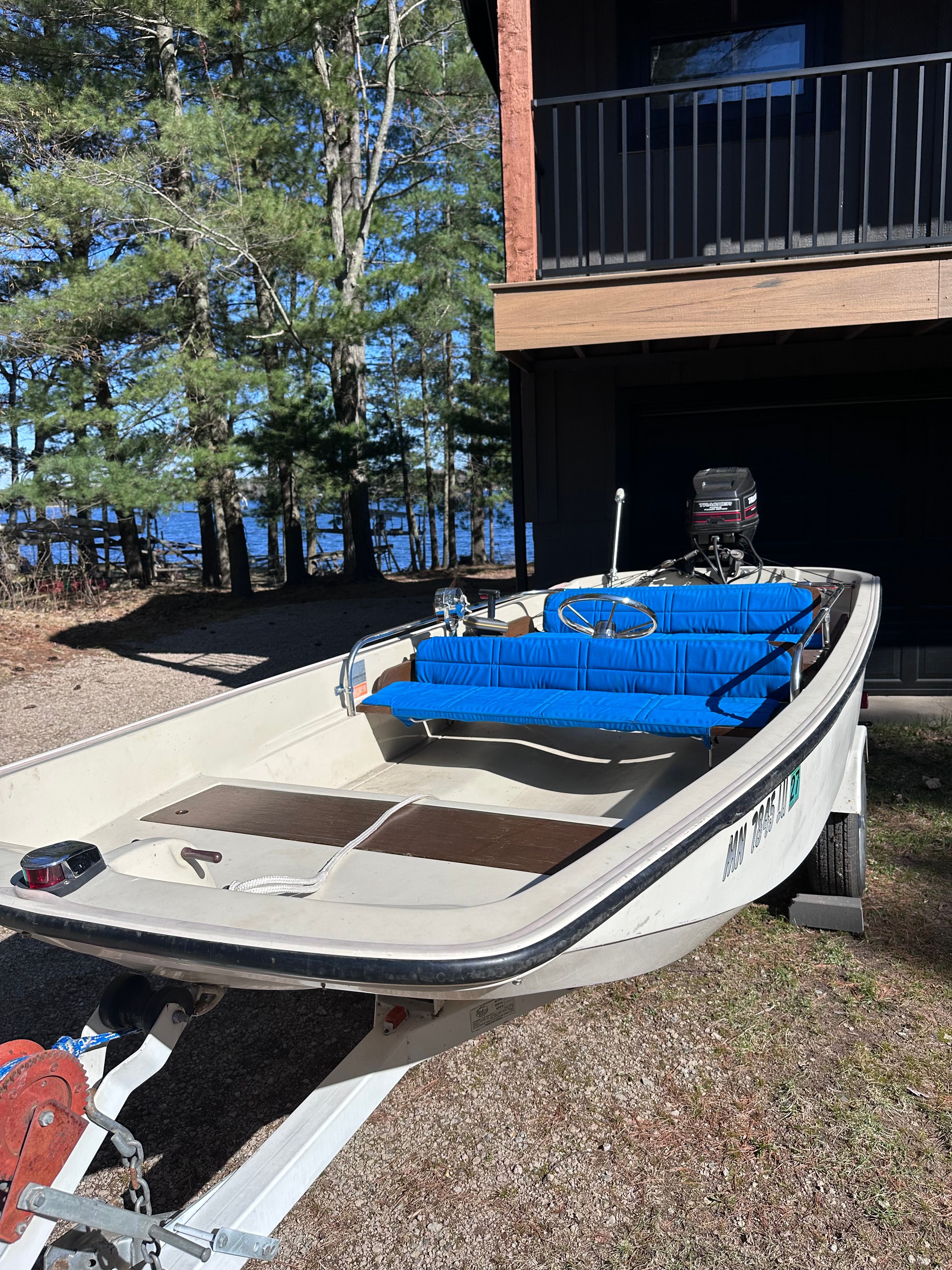 1973 Boston Whaler Sourpuss boat on trailer near house.