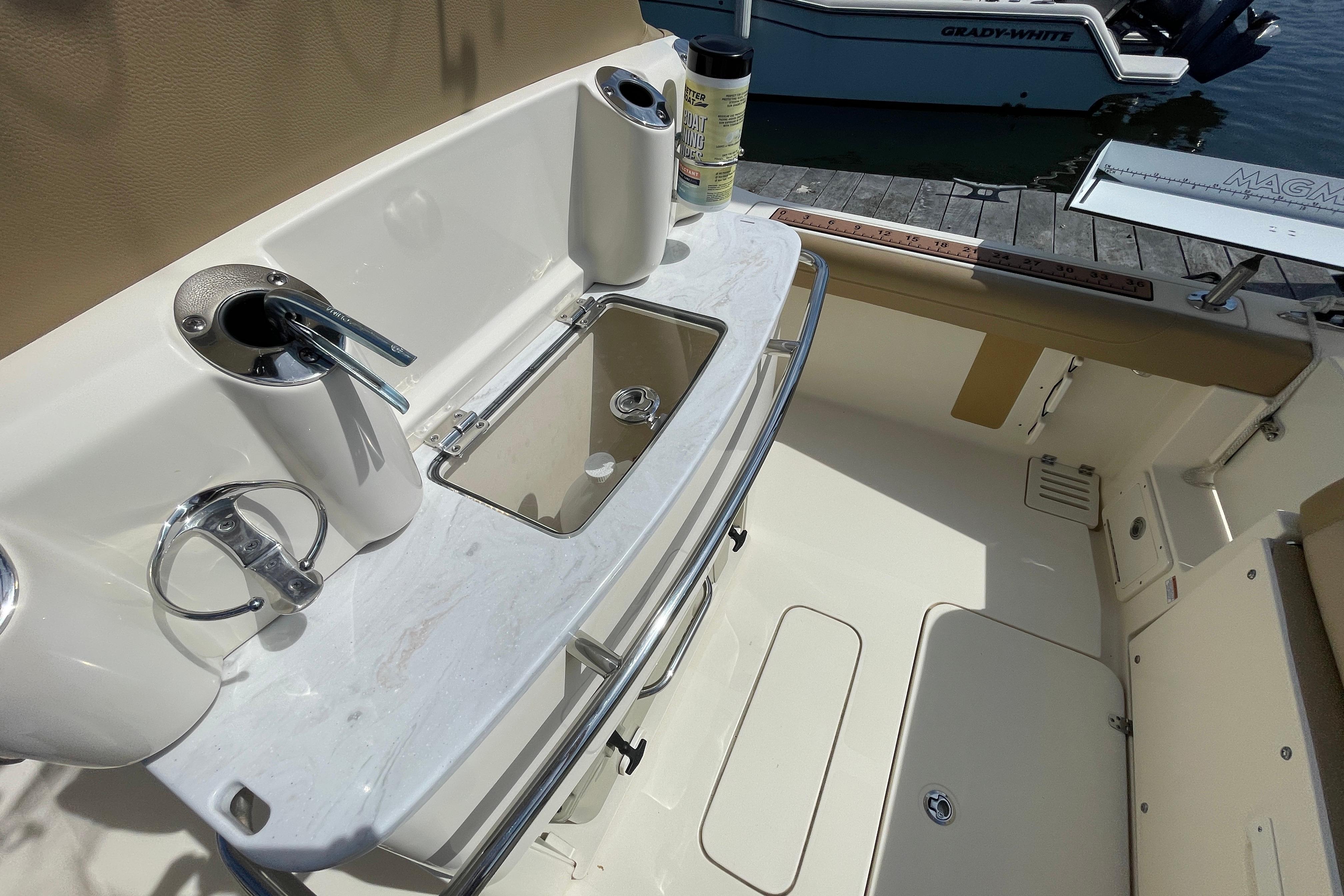 2020 Scout 255 LXF boat interior with fishing rod holders and bait station.