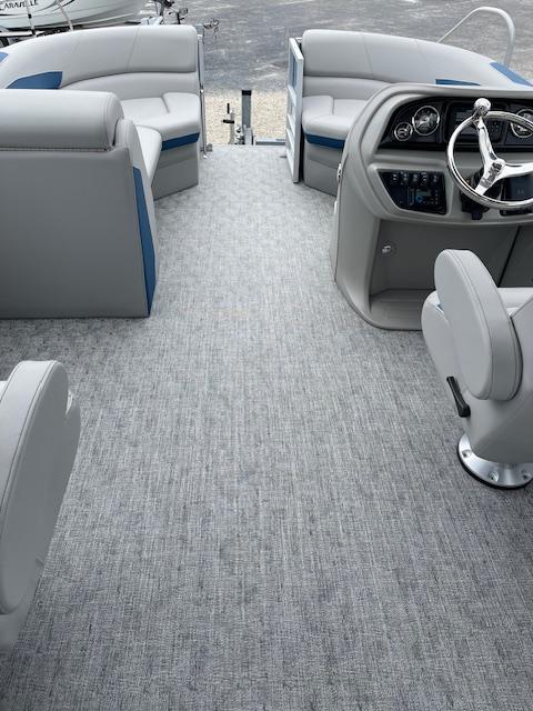 Interior of 2025 Berkshire 22 RFX LE Tri-toon Pontoon with gray seating and steering console.
