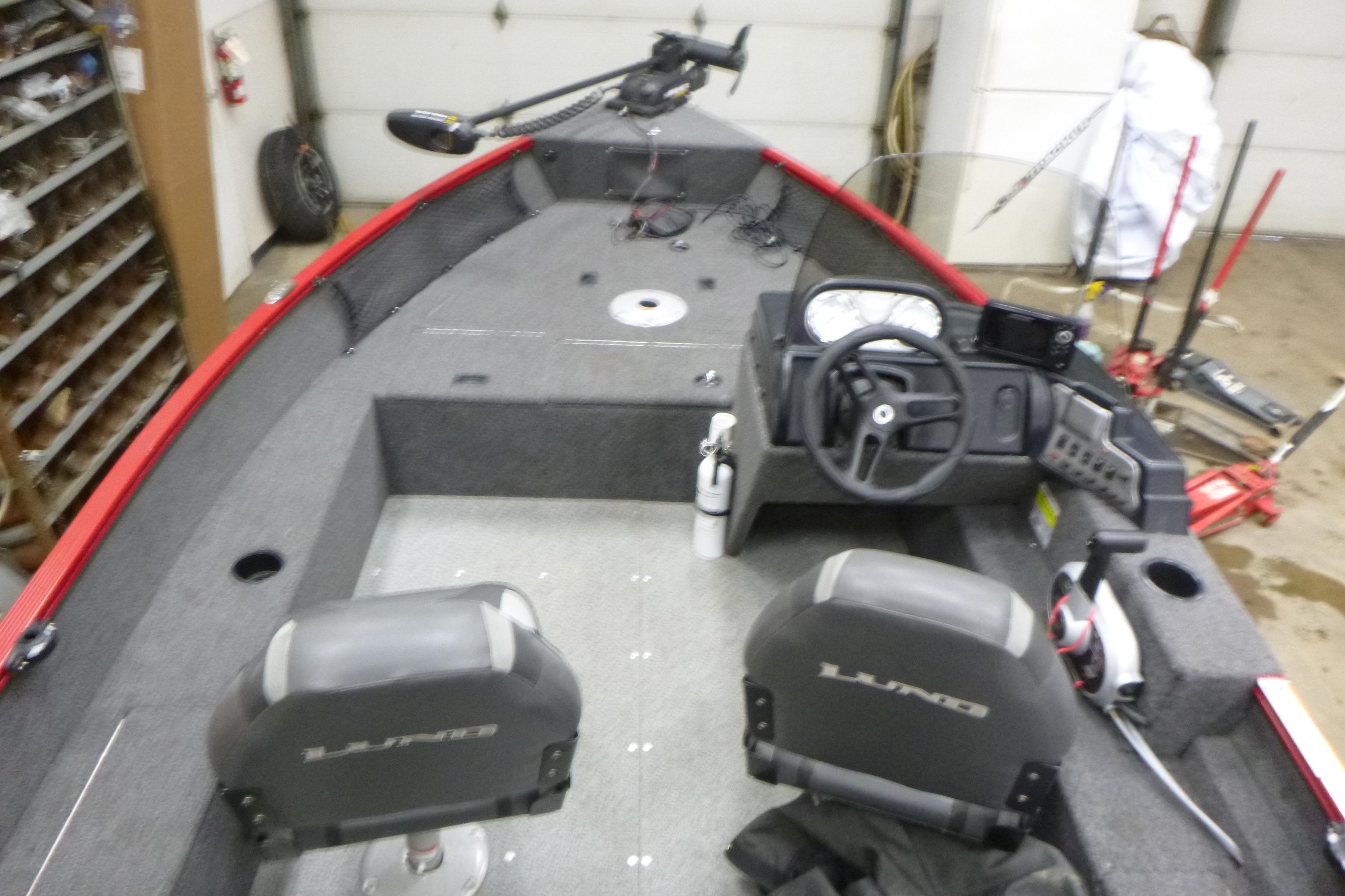 2022 Lund 1650 Angler Sport boat interior with steering console and seating.