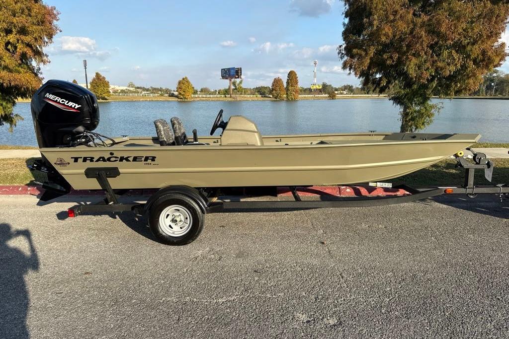 2026 Tracker Grizzly 1754 SC boat on trailer by a lake, featuring Mercury engine.