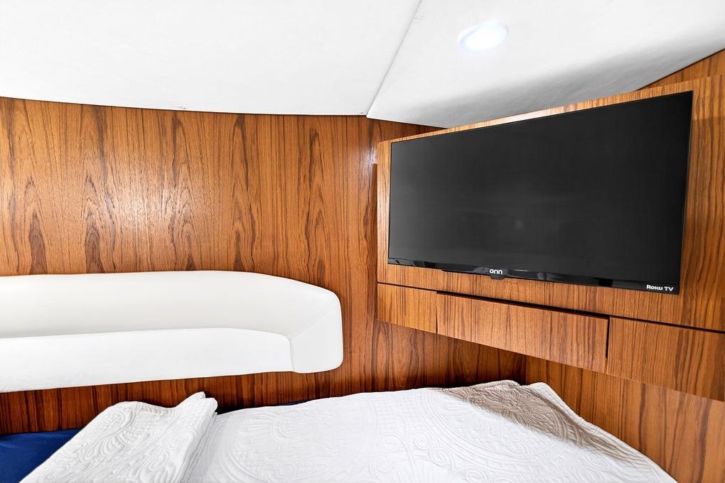 Interior of 2006 Tiara Yachts 4300 Sovran with wood paneling and mounted TV.
