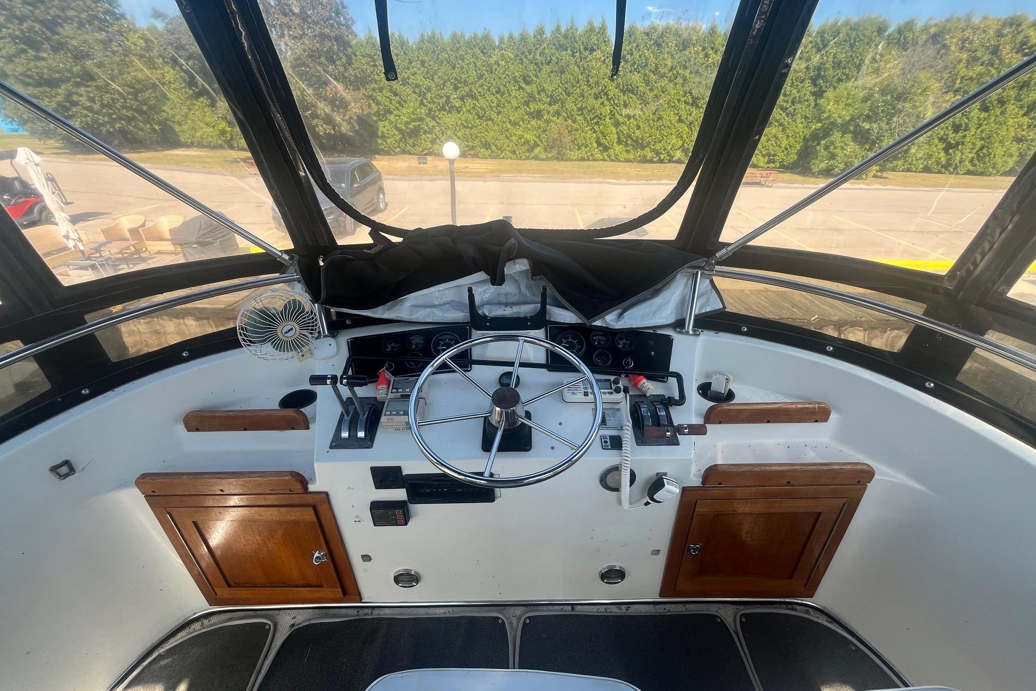 Cockpit of 1990 Cooper Prowler 35 boat with steering wheel and control panel.