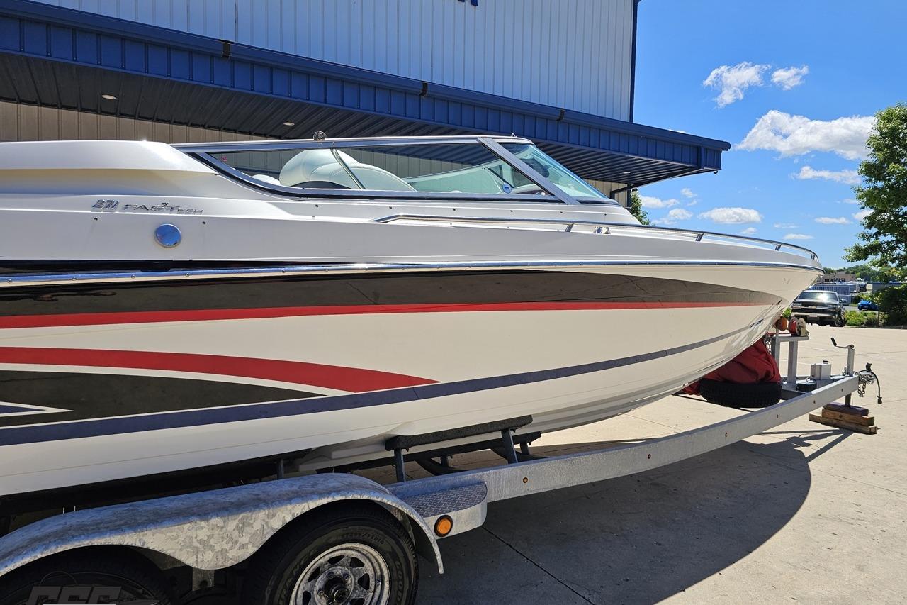 2005 Formula 271 FASTech boat on trailer, parked outdoors under a clear blue sky.