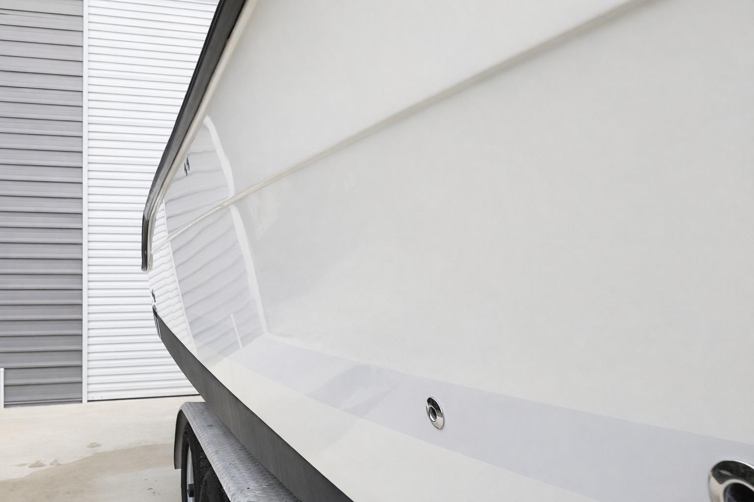2008 Hydra-Sports Vector 2900 CC boat hull, parked near a gray and white building.